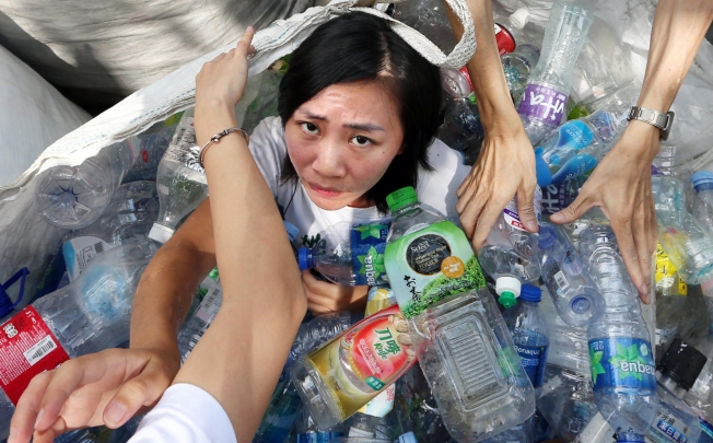Friends of the Earth member Celia Fung protests for a better government recycling policy. Photo: Sam Tsang