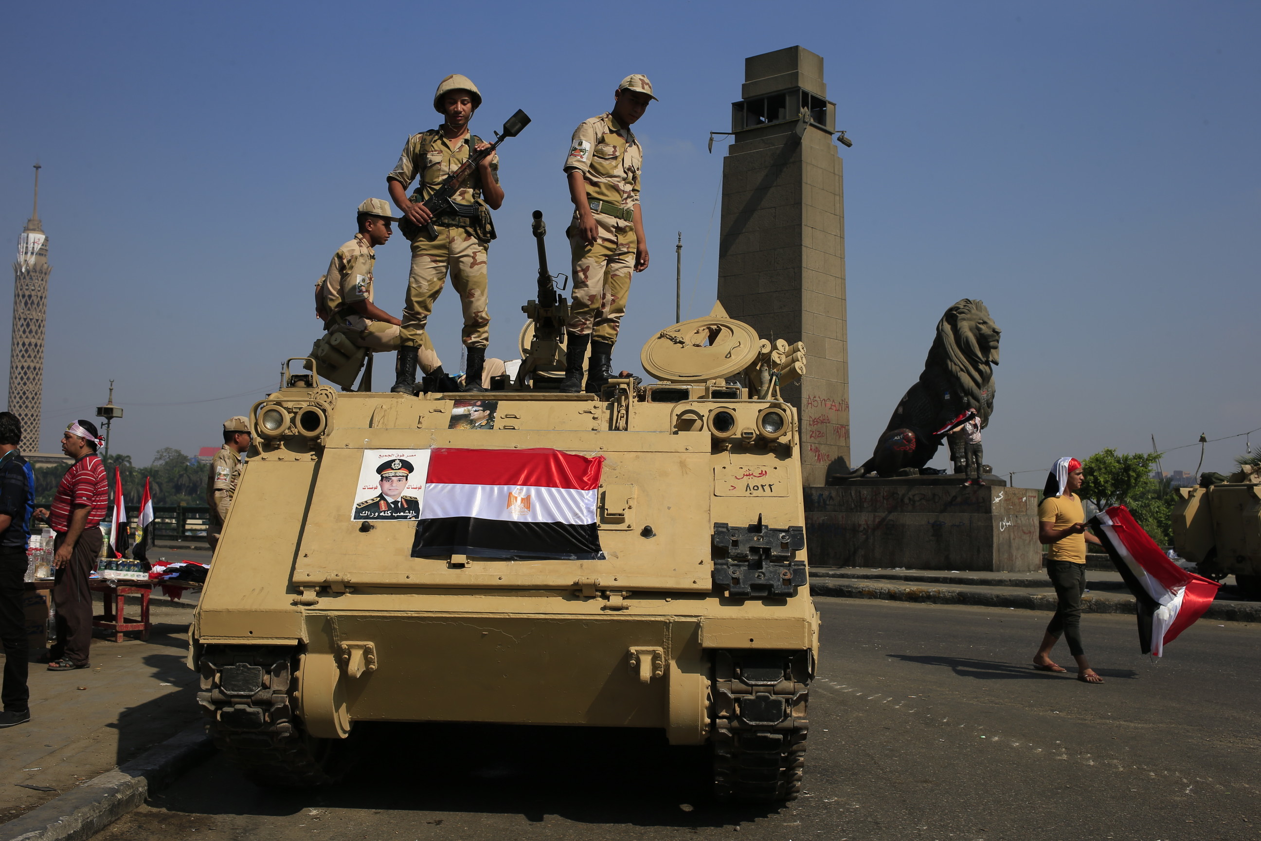 Egyptian soldiers stand guard atop an armored personnel vehicle on a bridge leading to Tahrir Square in Cairo. Photo: AP