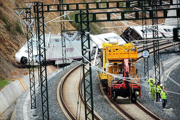 Rail workers inspect the tracks at the site of a train crash near Santiago de Compostela. Photo: Reuters