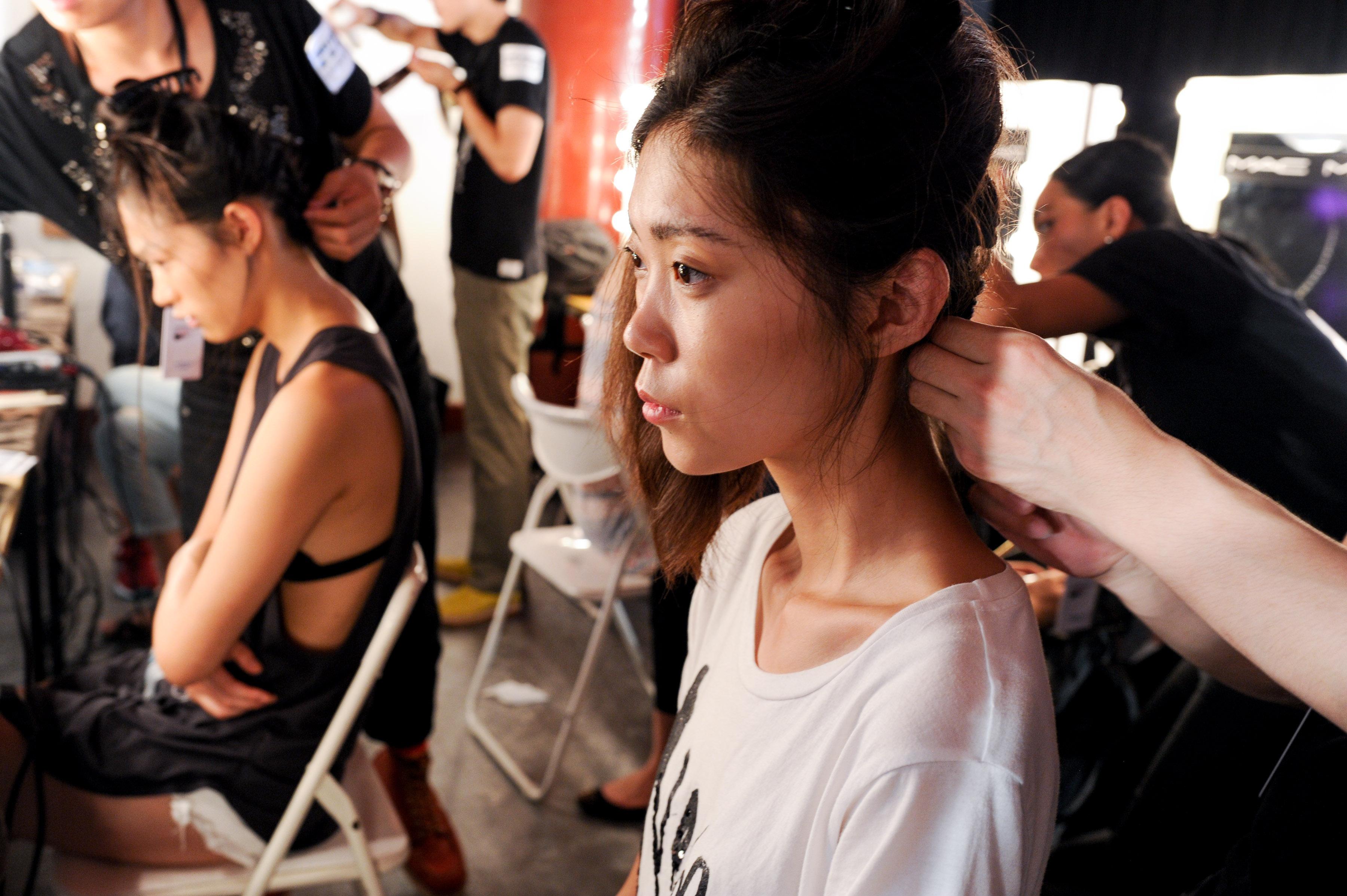 Models being prepared for a fashion show by New York-based designers in Beijing, China. Photo: AP