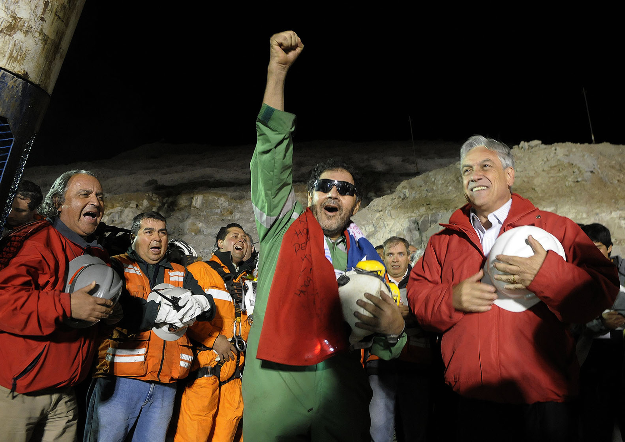 Chile's President Sebastian Pinera, right, stands next to the the last miner to be rescued, Luis Urzua, centre. Photo: AP