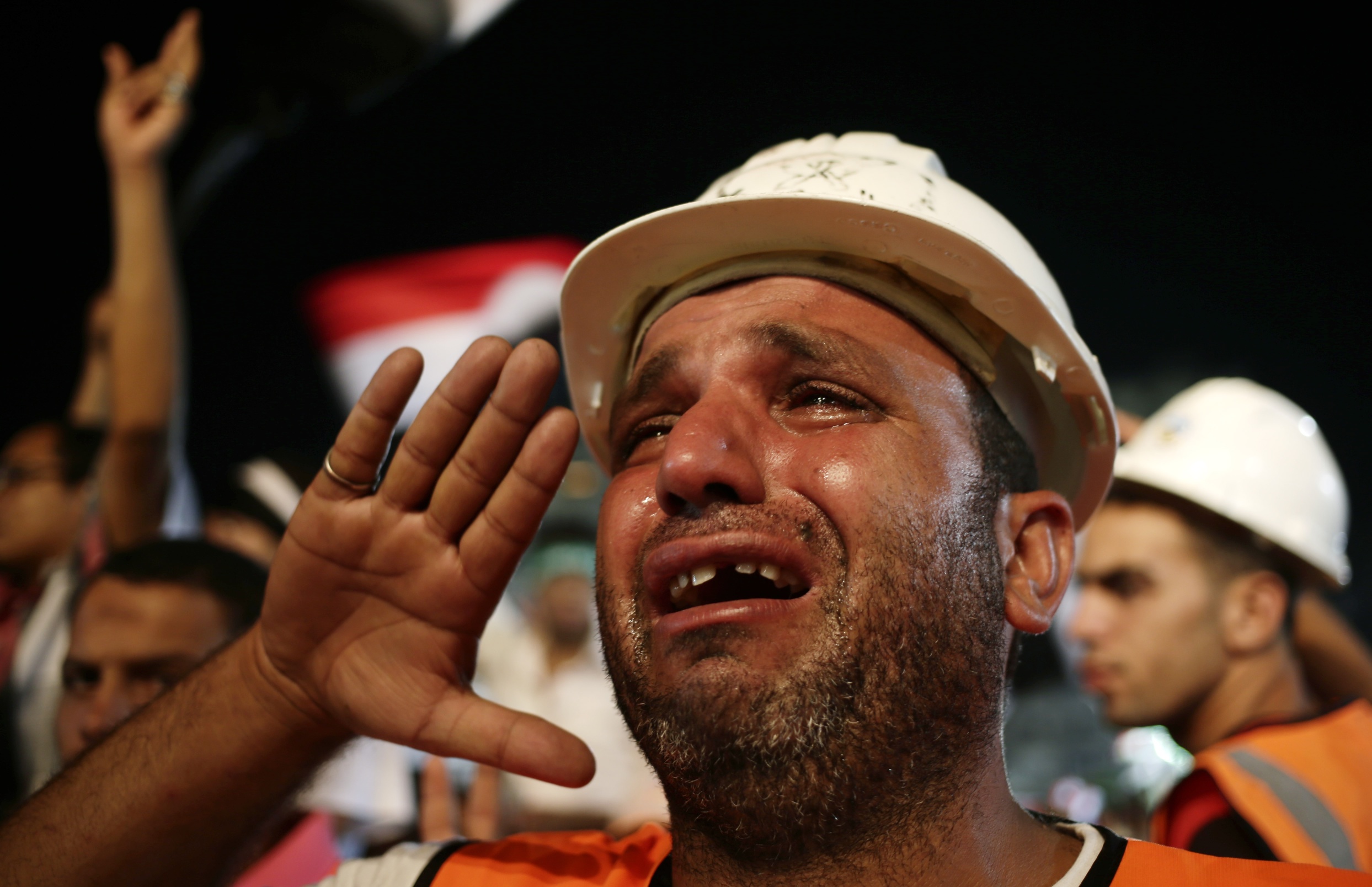 A supporter of Egypt's ousted President Mohammed Morsi cries while saluting the Egyptian flag at Rabaah al-Adawiya mosque, where supporters of Morsi hold daily rallies at Nasr City in Cairo. Photo: AP