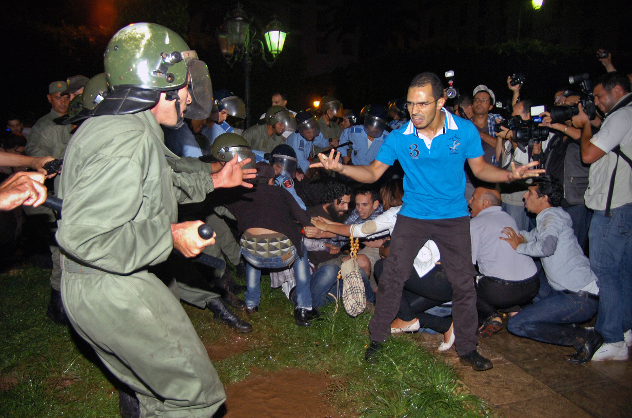 A demonstrator confronts a police officer in Rabat, Morocco. Photo: AP