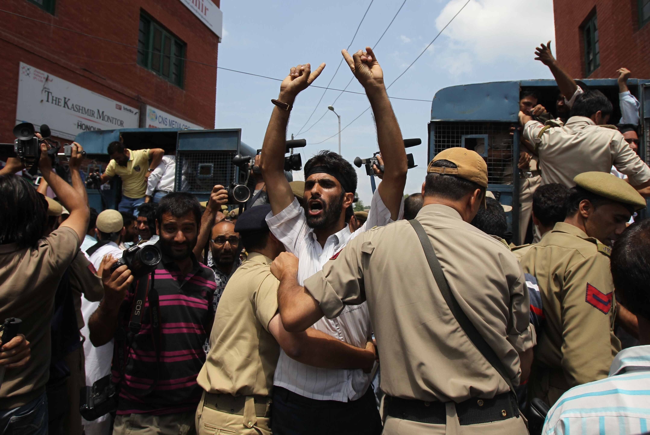  Indian policemen detain a man during a protest in Srinagar, summer capital of Kashmir. Pakistani troops have killed five Indian soldiers in an attack on Kashmir. Photo: Xinhua