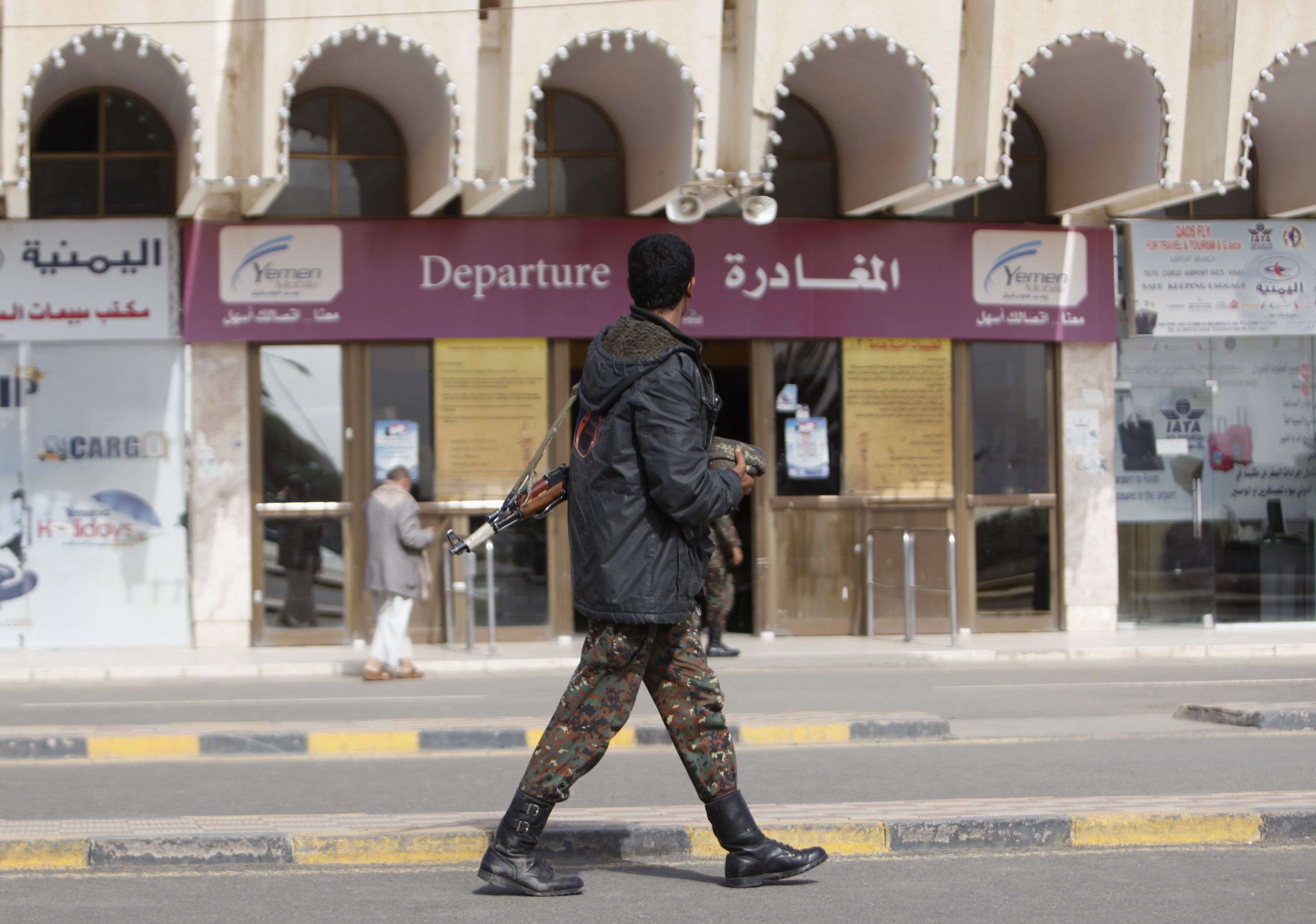 A police trooper walks outside Sanaa International Airport, Yemen. Photo: Reuters