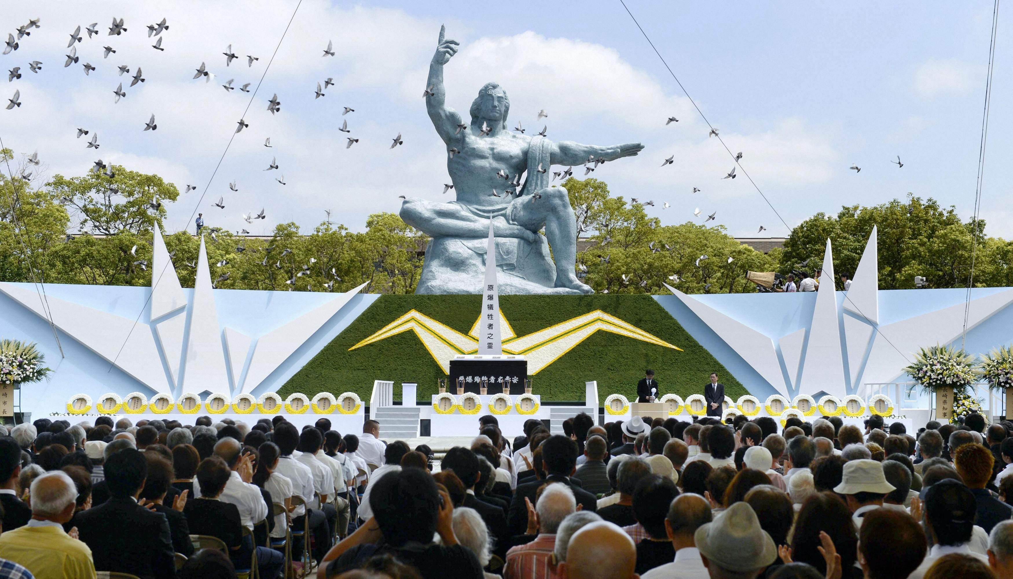 Doves fly near the Peace Statue in Nagasaki's Peace Park during a ceremony commemorating the 68th anniversary of the bombing