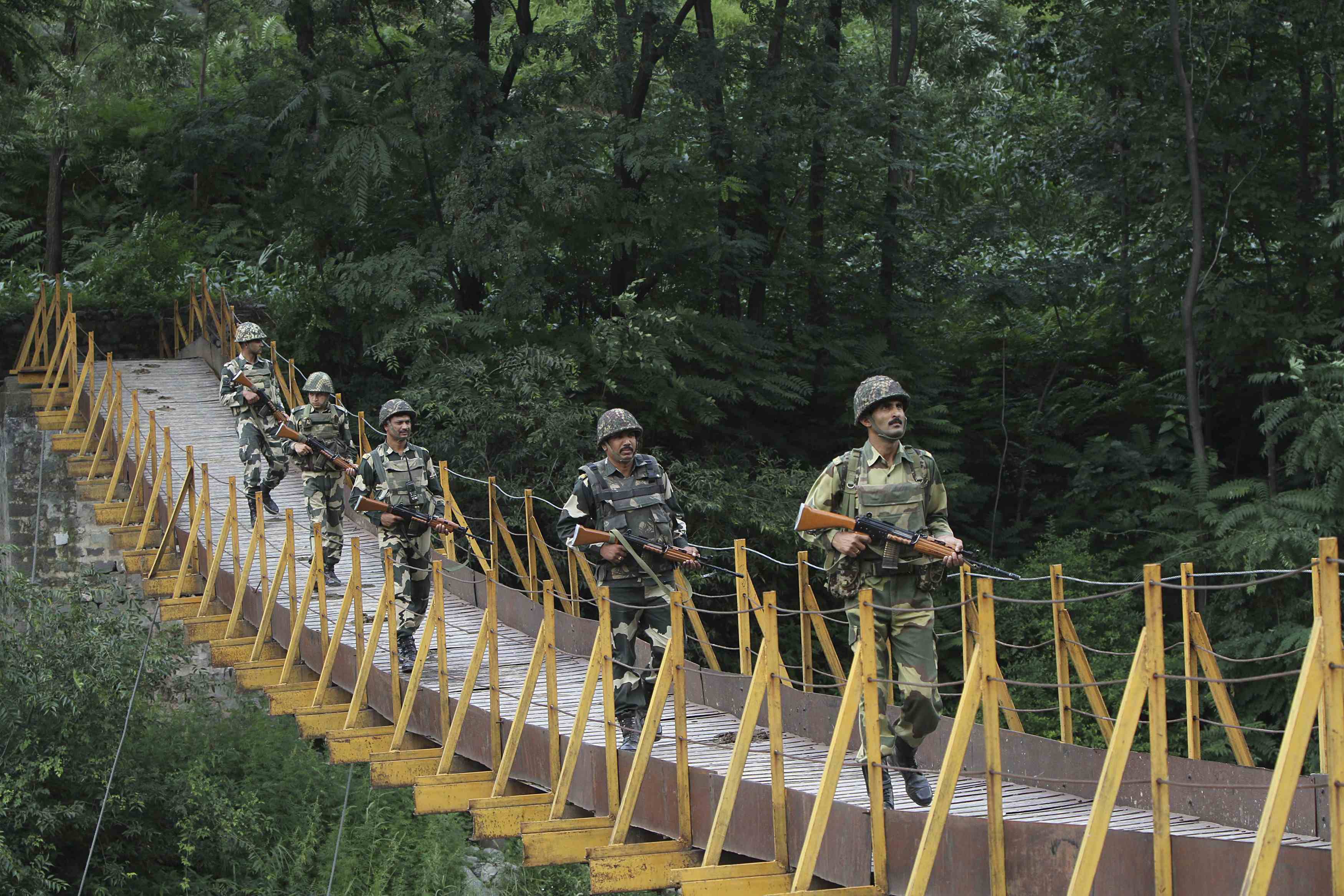 Indian Border Security Force soldiers patrol over a footbridge built over a stream near the Line of Control. Photo: Reuters
