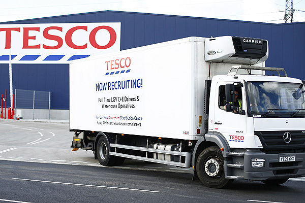 A lorry with job advertisements on its side leaves a Tesco distribution centre in Dagenham, east London. Photo: Reuters
