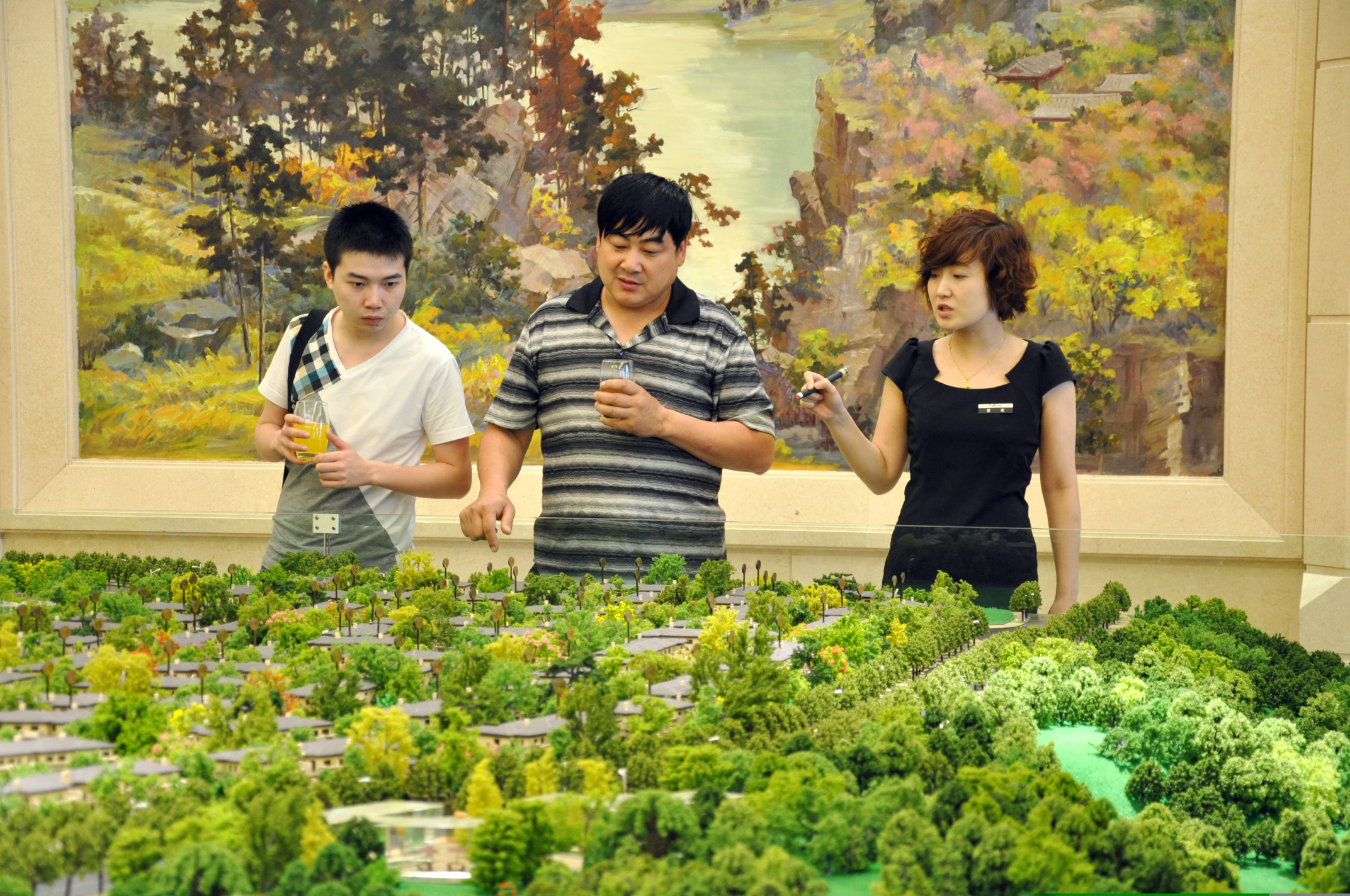  Potential buyers look over a model of a Longfor Properties development in Chongqing. Photo: Paggie Leung