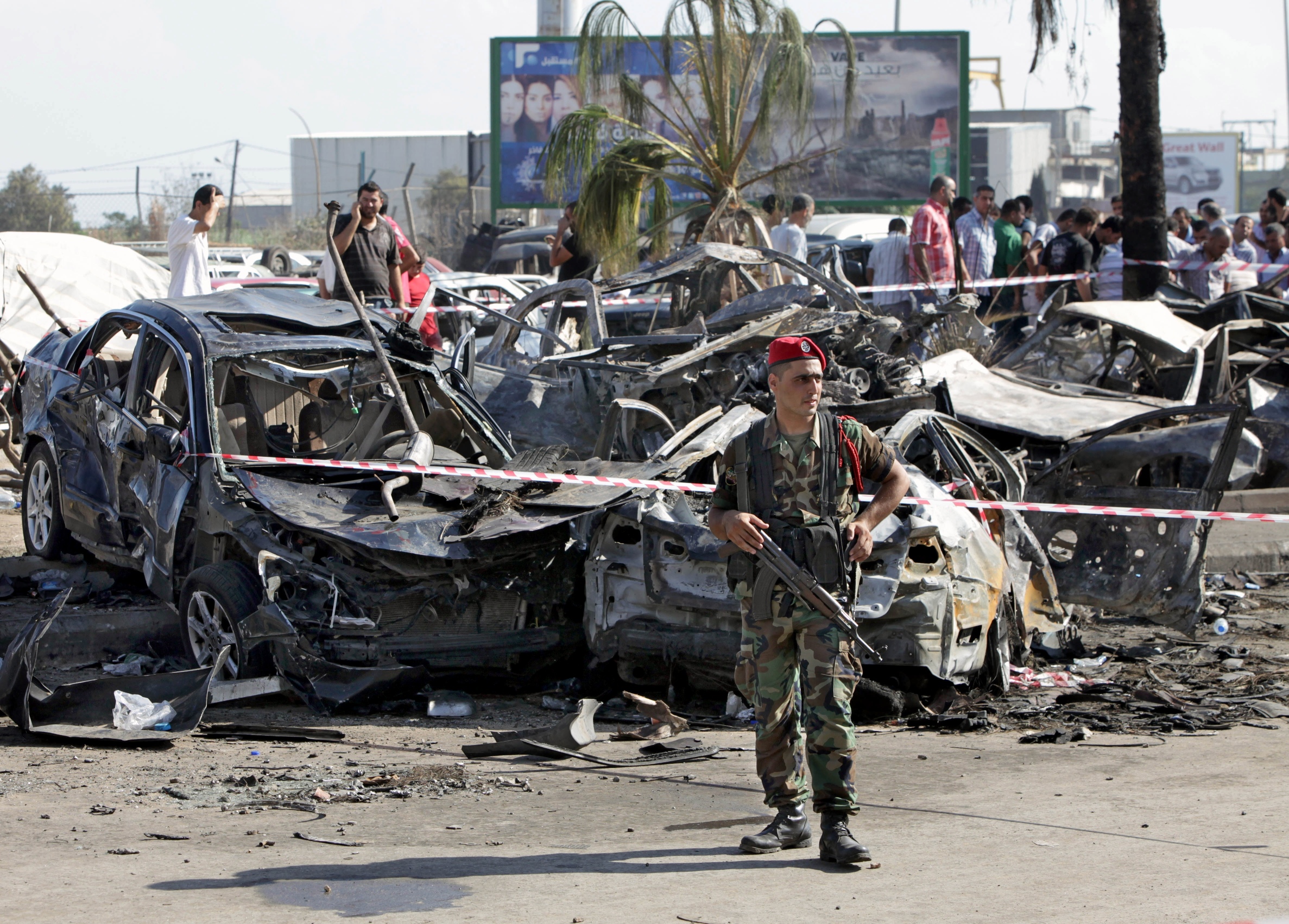 A Lebanese Army soldier stands guard in front of damaged cars at the site of a car bomb explosion outside of the Al-Taqwa mosque, in the northern city of Tripoli, Lebanon, on Saturday. Photo: AFP