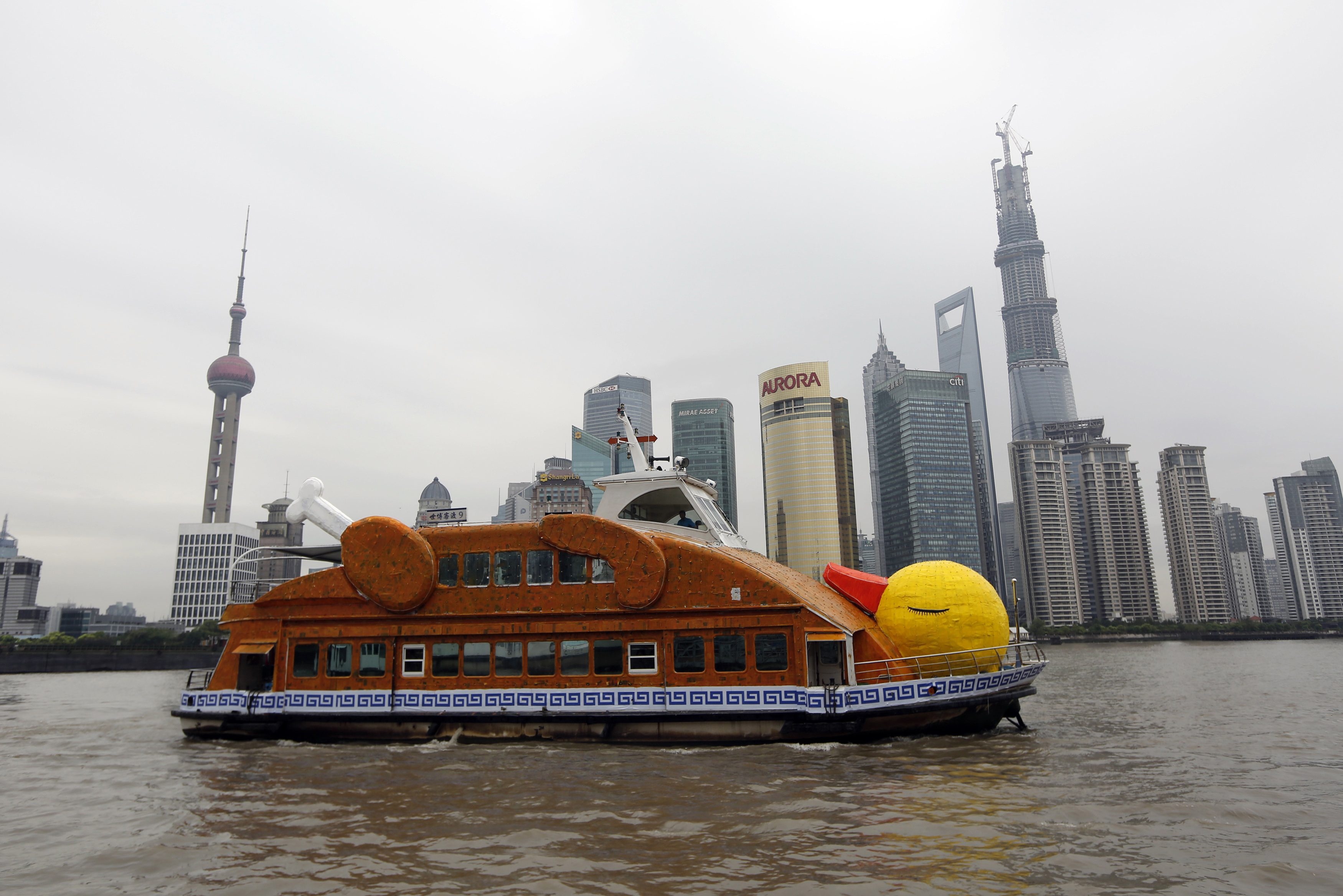 A boat made to look like a roasted duck is seen on the Huangpu River in front of the financial district of Pudong in Shanghai. Photo: AFP
