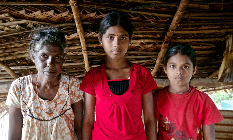 Rajithini (right), seen in this photo taken in Mullaithivu in August, lost her parents in the civil conflict and now lives with her eldest sister and grandma. Photo: World Vision Hong Kong