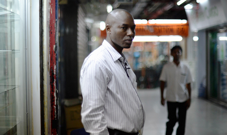  39-year-old trader Ali Diallo from Guinea, who sells Chinese electronics to retailers across Africa, stands outside his shop in Chungking Mansions in Hong Kong. Photo: AFP