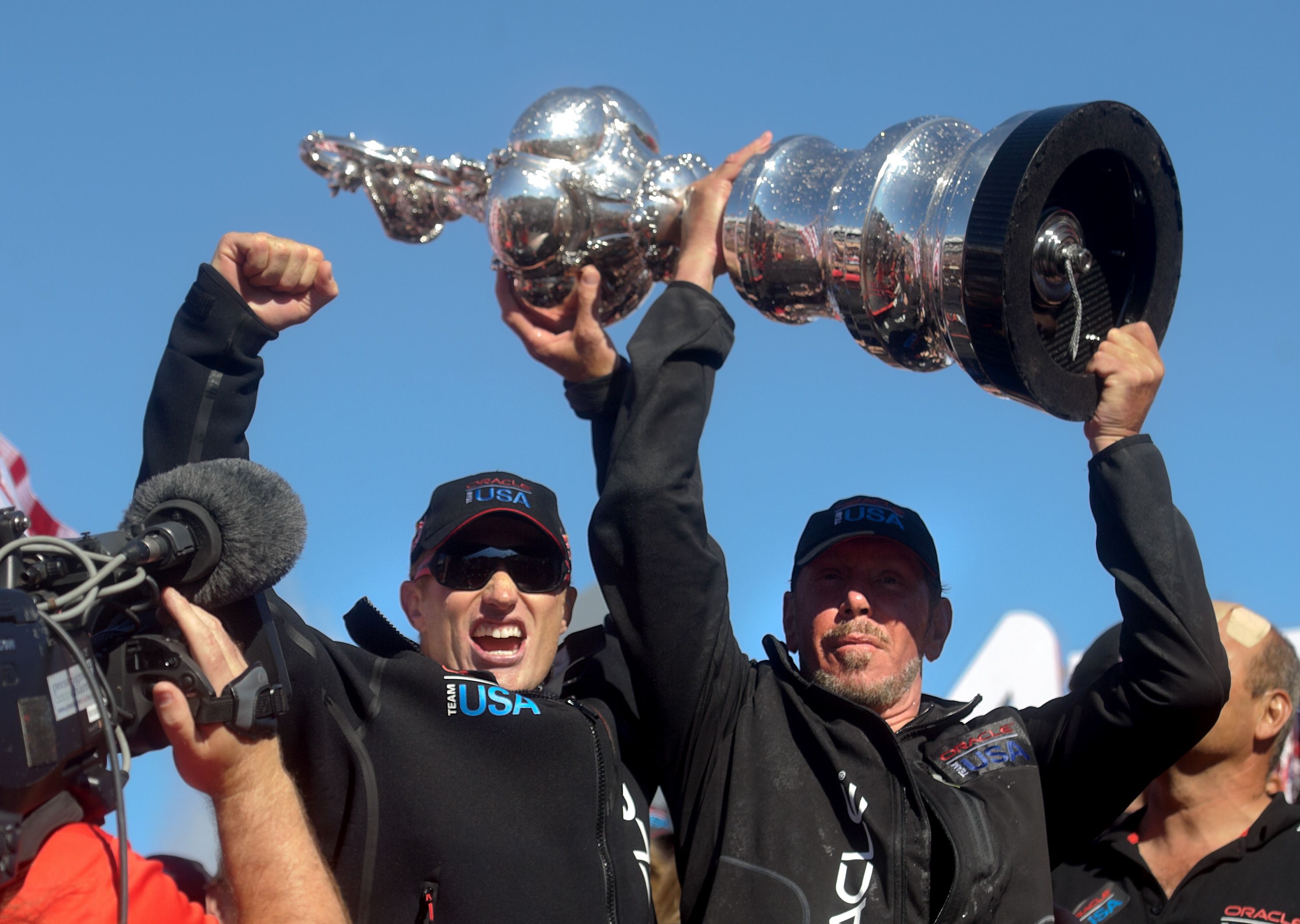 Oracle Team USA skipper Jimmy Spithill (left) and Oracle Corp. CEO Larry Ellison hoist the America's Cup trophy after beating Emirates Team New Zealand in San Francisco. Photo: AFP