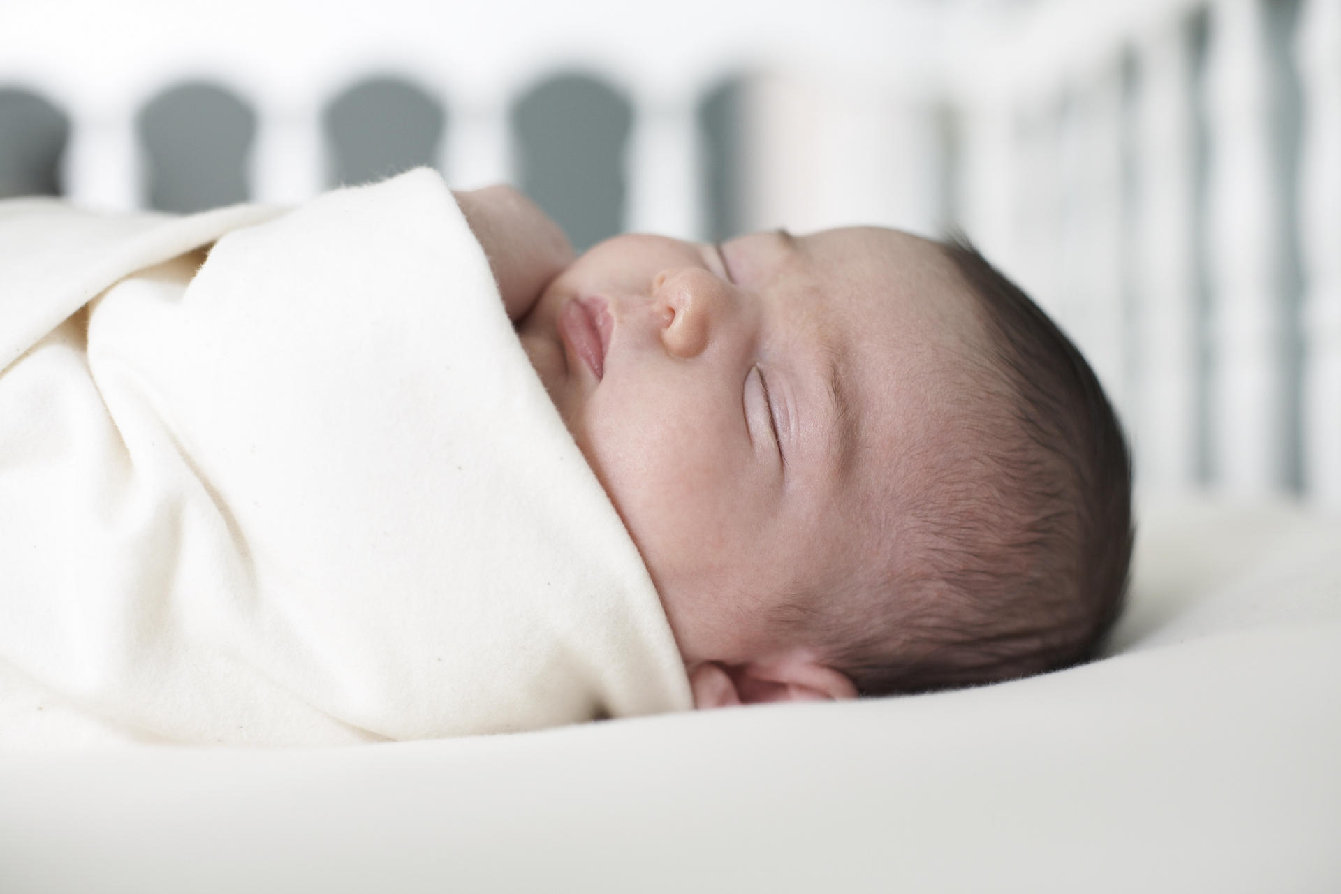 Sleeping baby on his back can lead to flat head syndrome. Photo: Corbis
