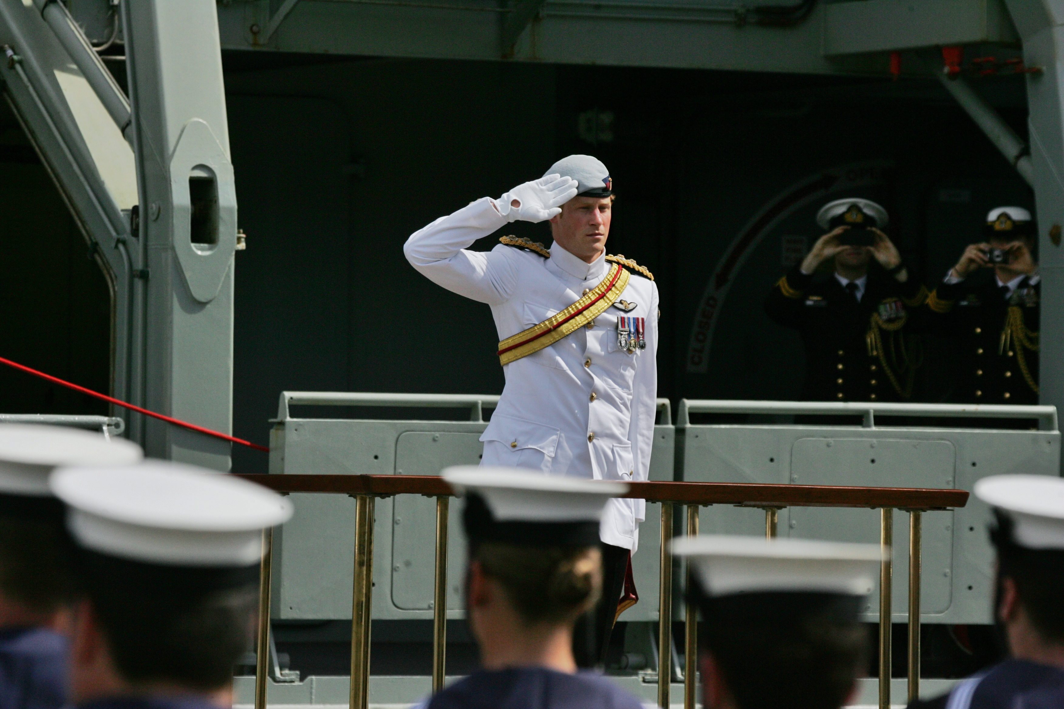  Prince Harry salutes the ceremonial guards at Garden Island Naval Base for the International Fleet Review in Sydney. Photo: EPA