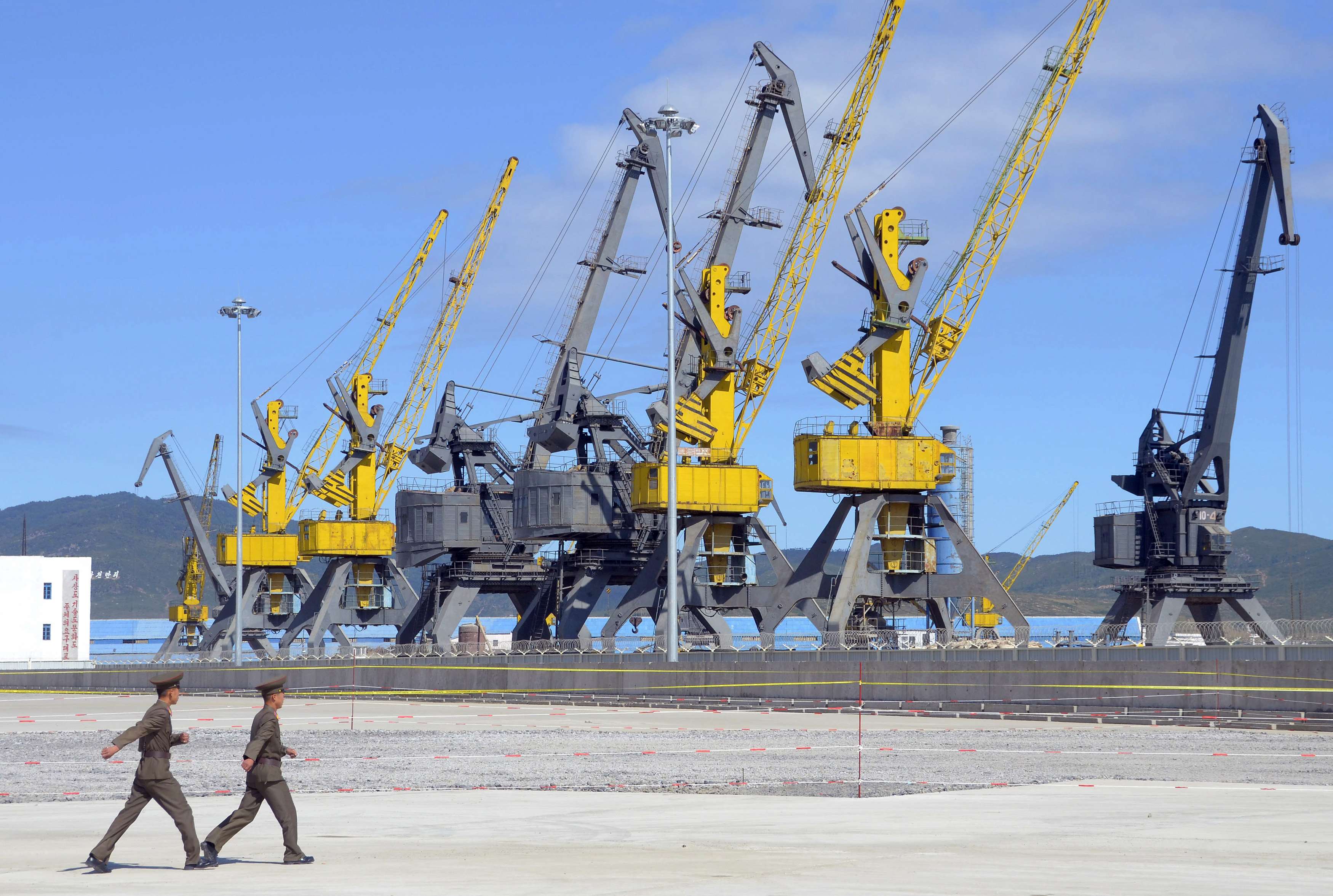 North Korean soldiers march near loading machinery at the port of Rajin. Photo: Reuters