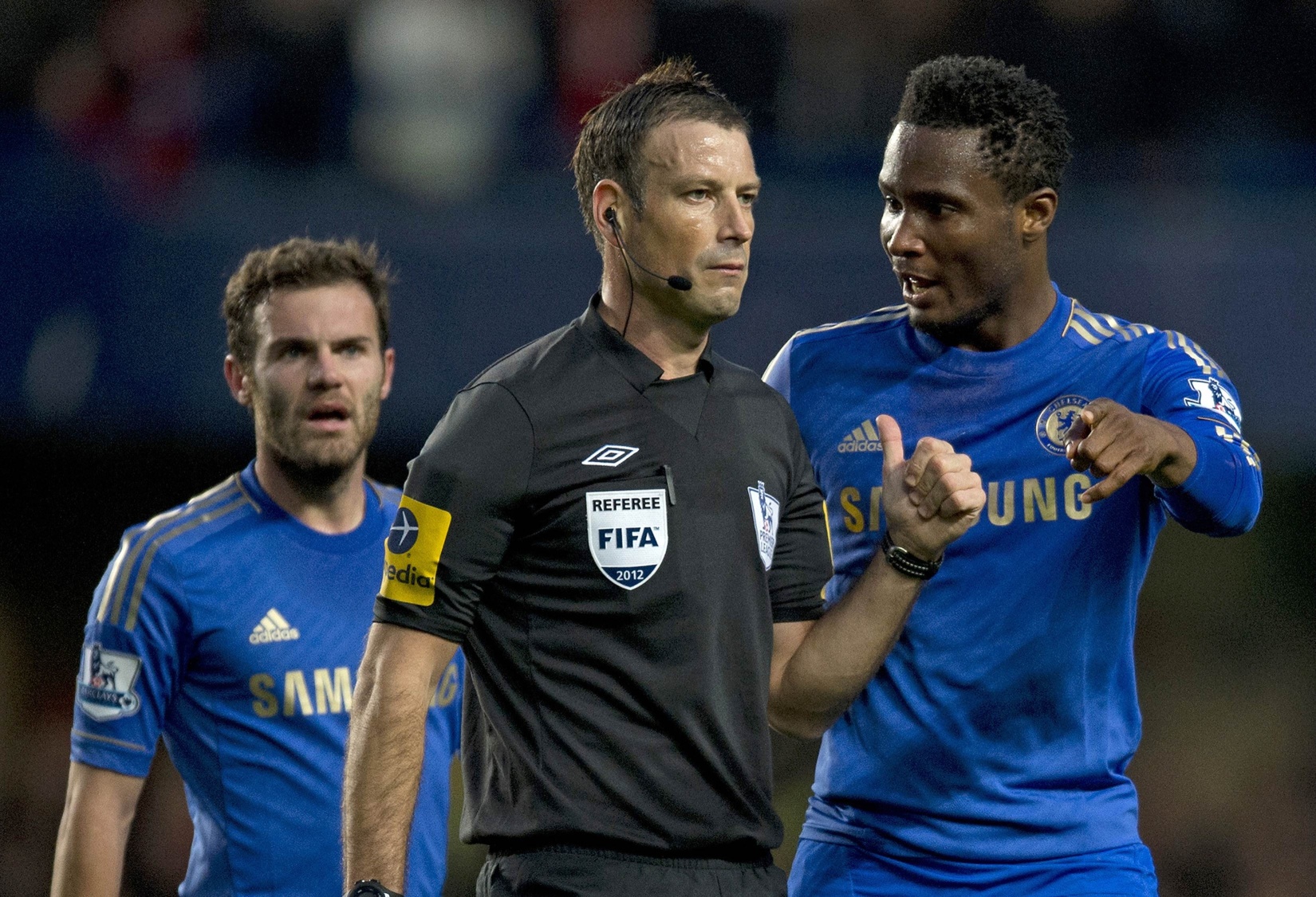 Chelsea's midfielder John Mikel Obi talking with referee Mark Clattenburg during a match against Manchester United earlier this month. There were complaints about racist comments during the game. Photo: AFP