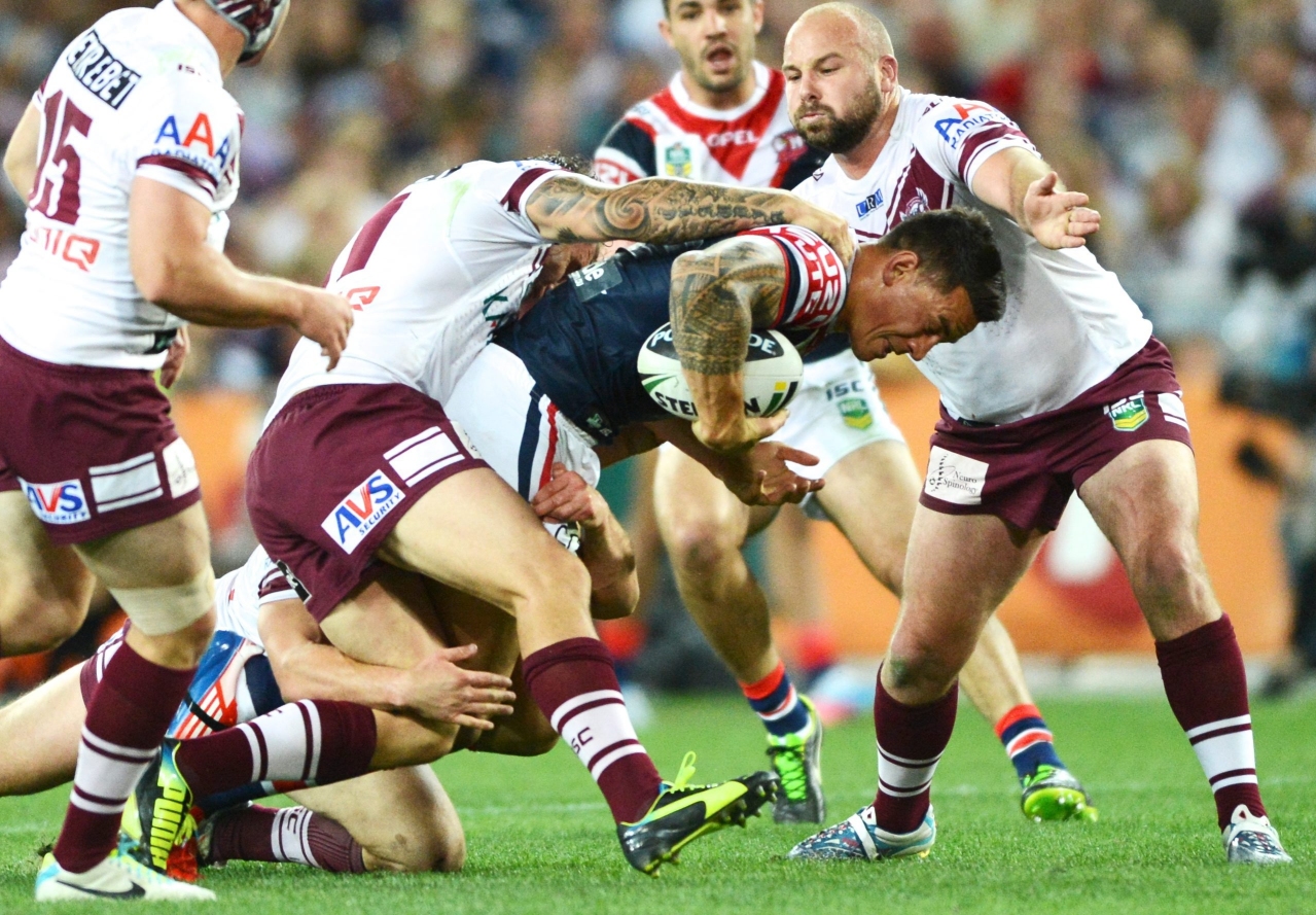 Sonny Bill Williams is tackled during the grand final between the Sydney Roosters and the Manly Sea Eagles in Sydney on Sunday. Photo: EPA