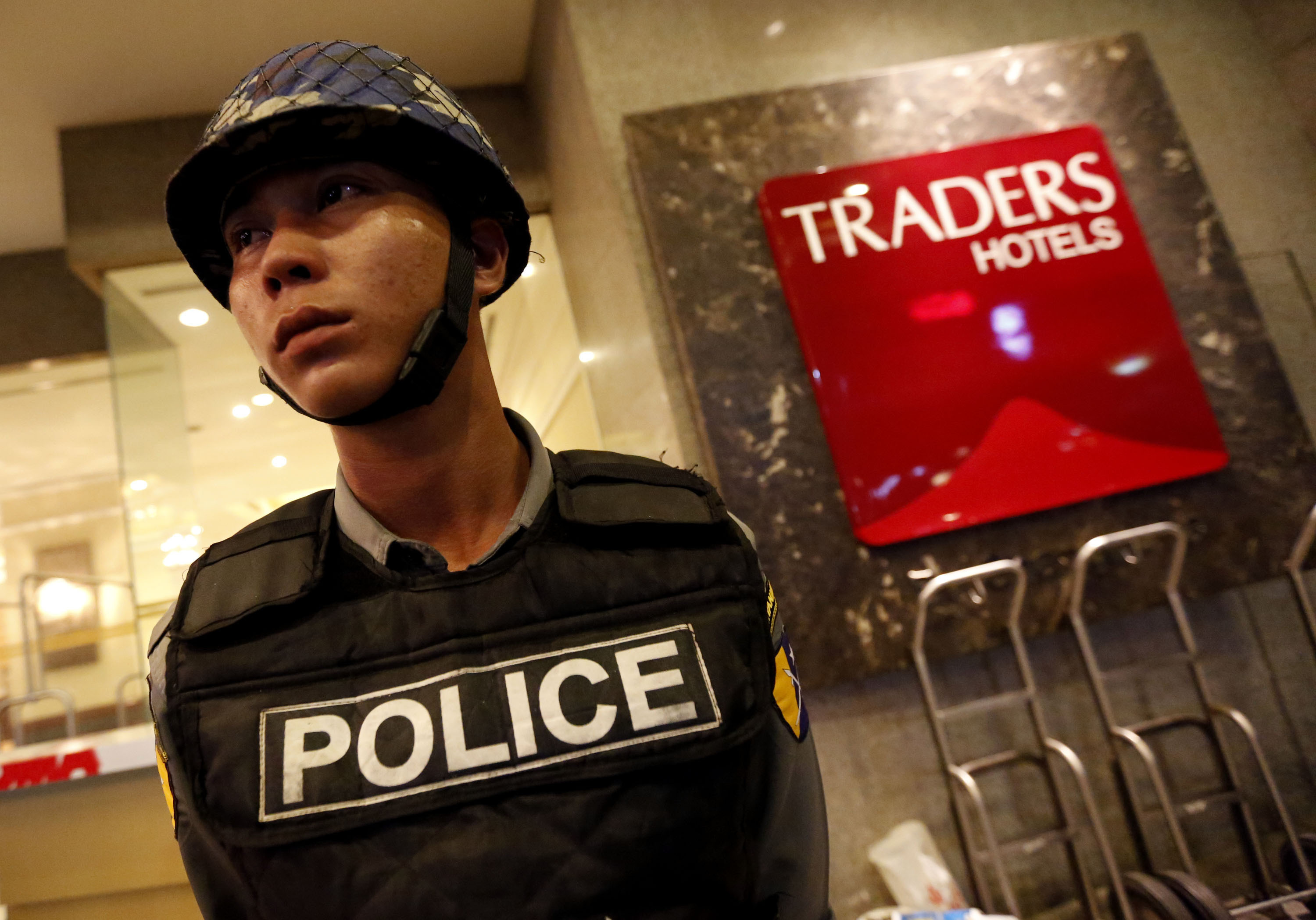 A policeman stands guard in front of the Traders Hotel in Yangon, Myanmar, after an explosion. Photo: Xinhua