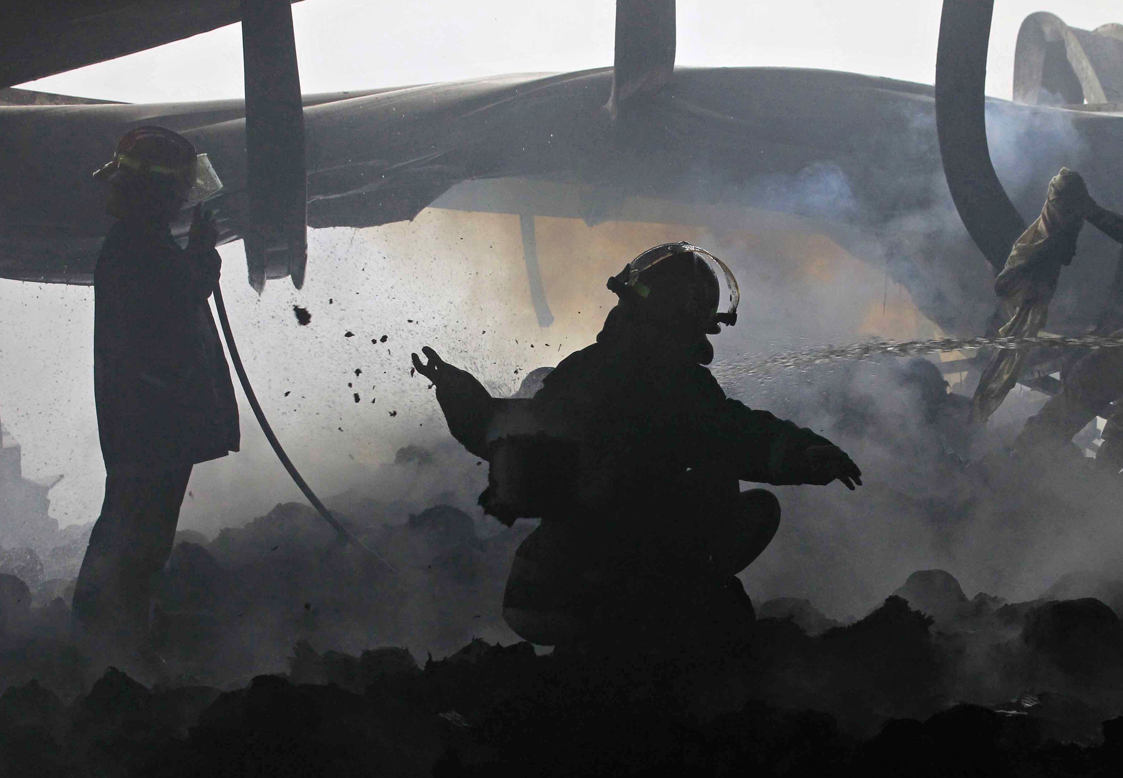 Bangladeshi firefighters at the scene after a fire at a garment factory in Sripur. Bangladesh is launching a safety campaign to overhaul conditions at garment factories. Photo: AFP