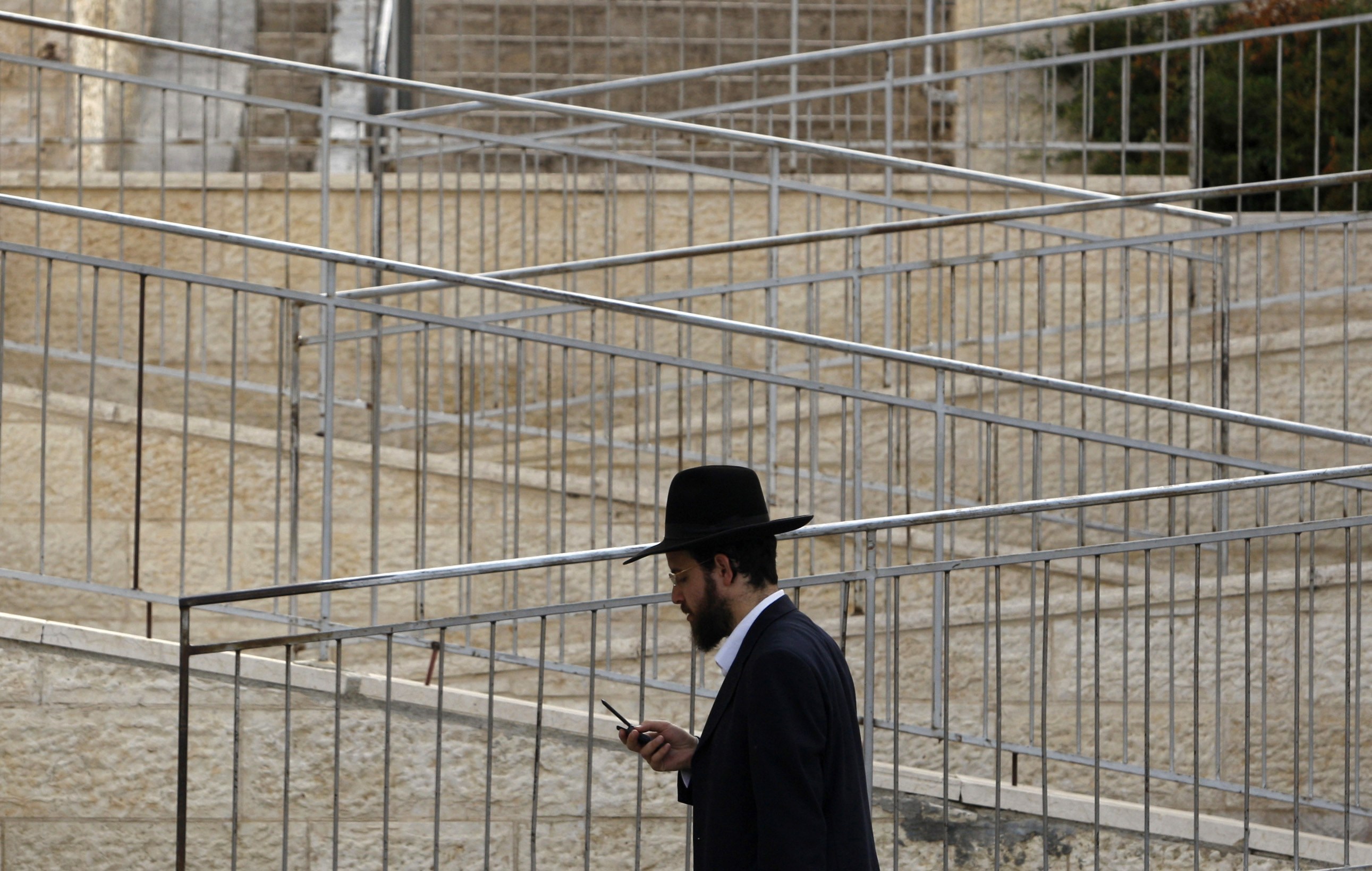 An ultra-Orthodox Jew holds walks through Ramat Shlomo, a  settlement in the occupied West Bank. Photo: Reuters