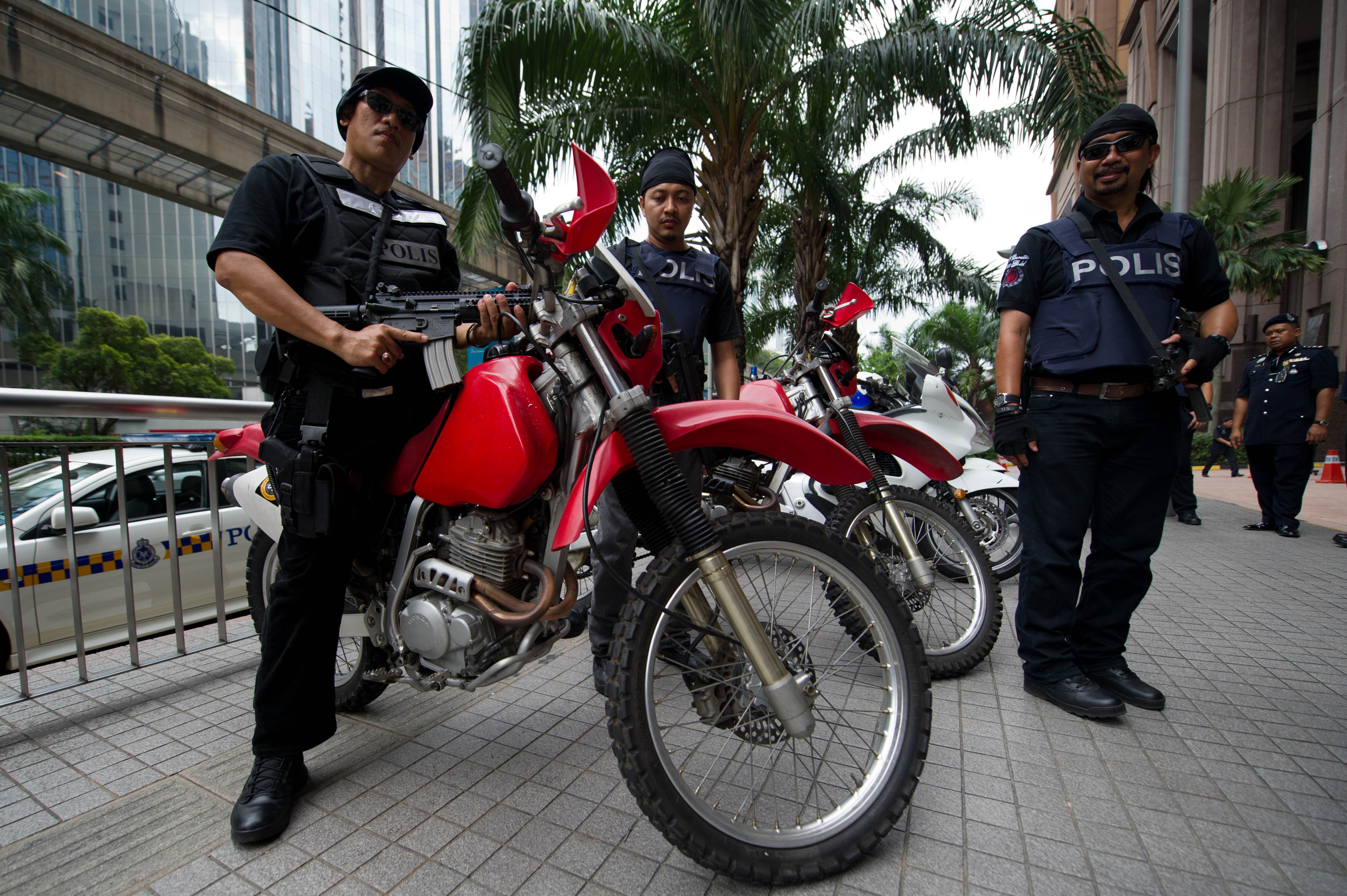 Malaysian policemen are battling against gang violence blamed on drug-trafficking turf wars, easily obtained guns, and government policies that critics say marginalise ethnic Indians. Photo: AFP
