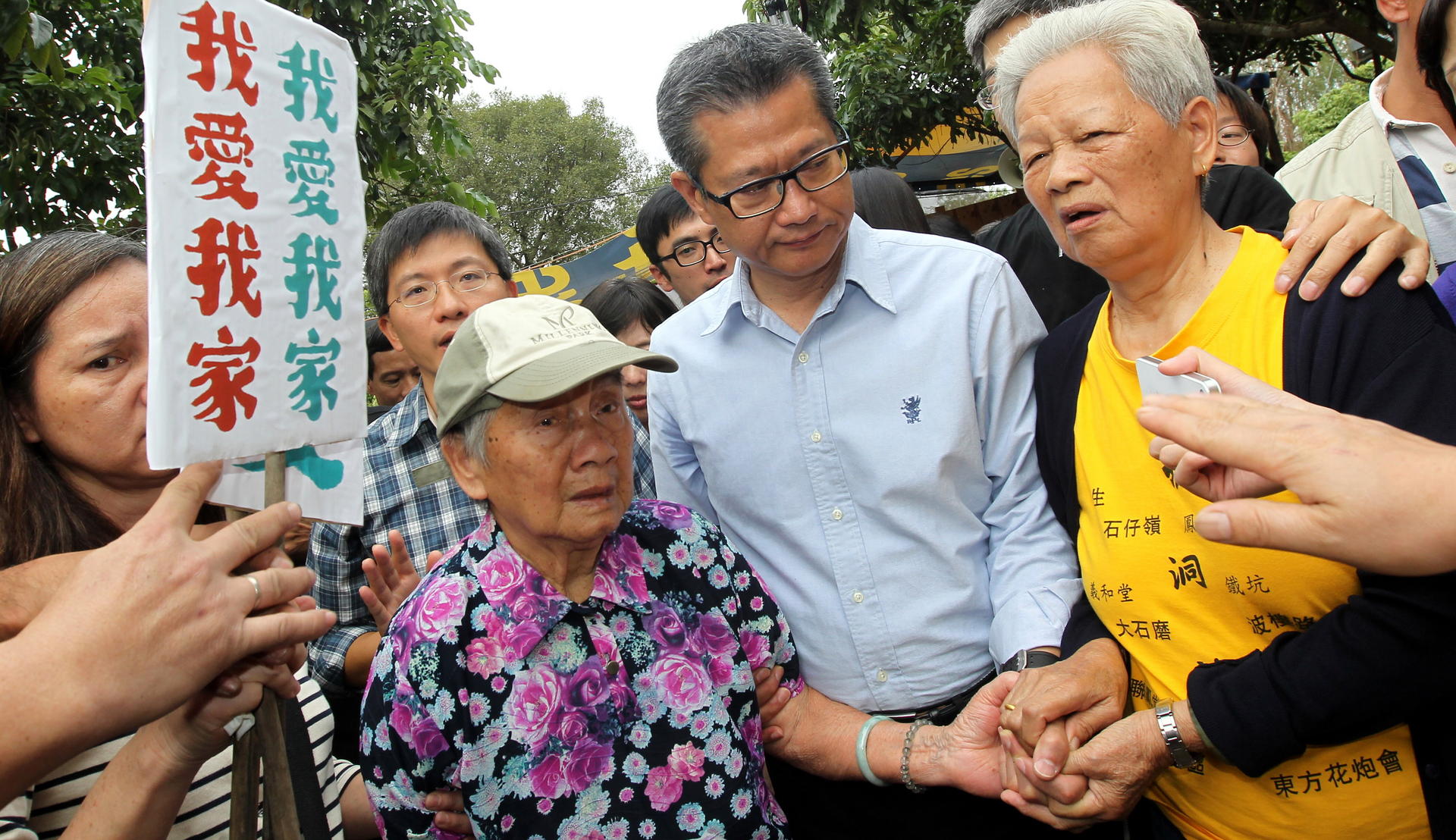 Paul Chan (centre) in Kwu Tung with residents who will be forced to move. Photo: Dickson Lee