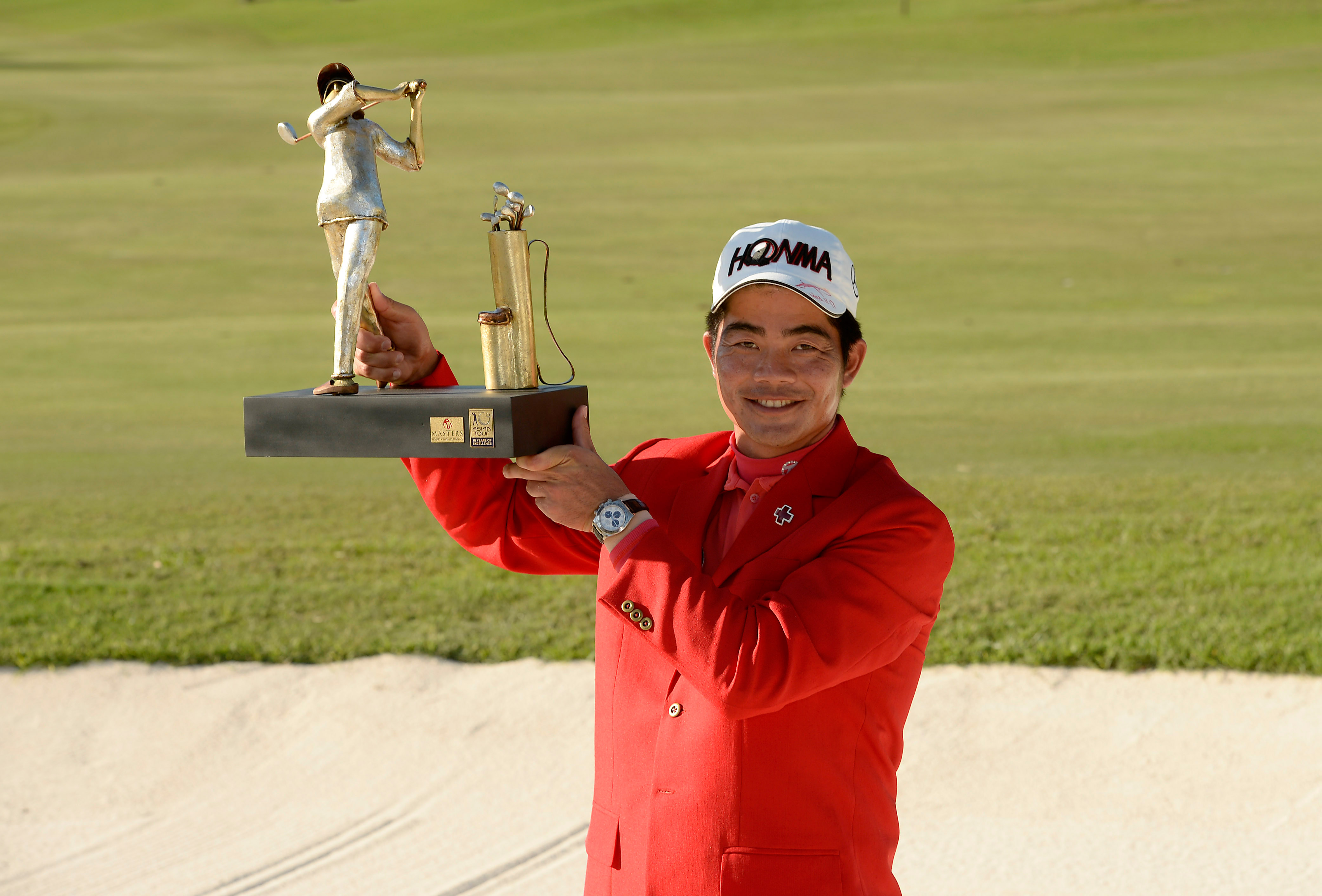 China's Liang Wenchong with his Manila Masters trophy after winning his third Asian Tour title. Photo: AFP    