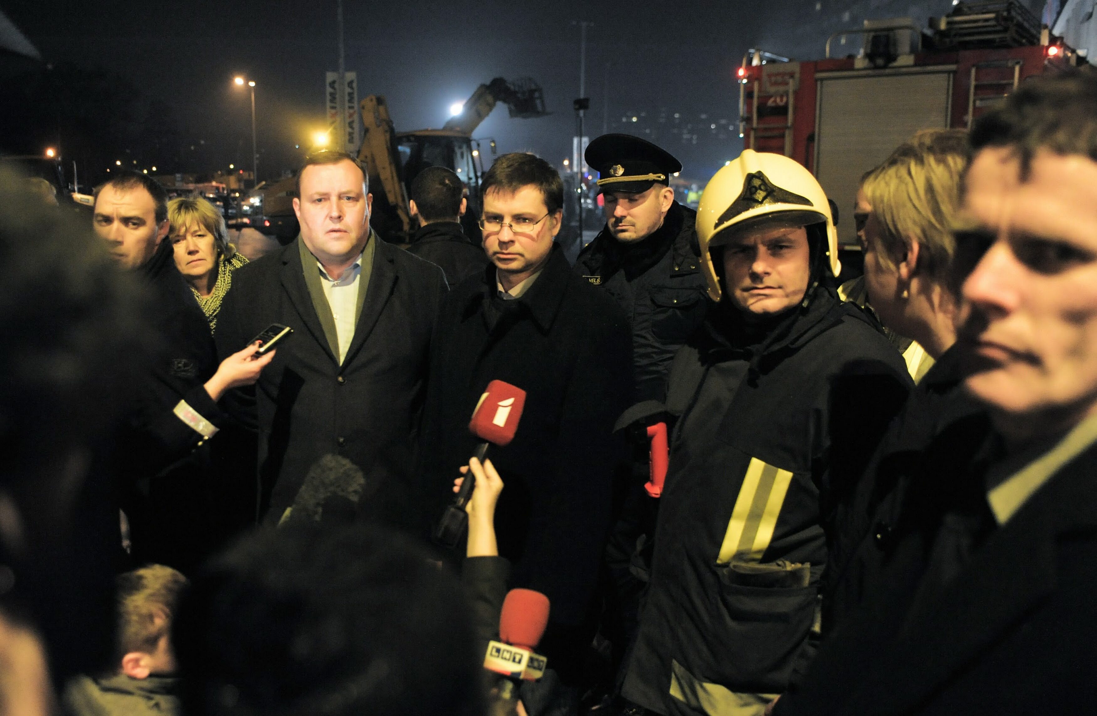 Latvian Prime Minister Valdis Dombrovskis (centre) outside the Maxima supermarket  in Riga after its roof collapsed. Photo: EPA