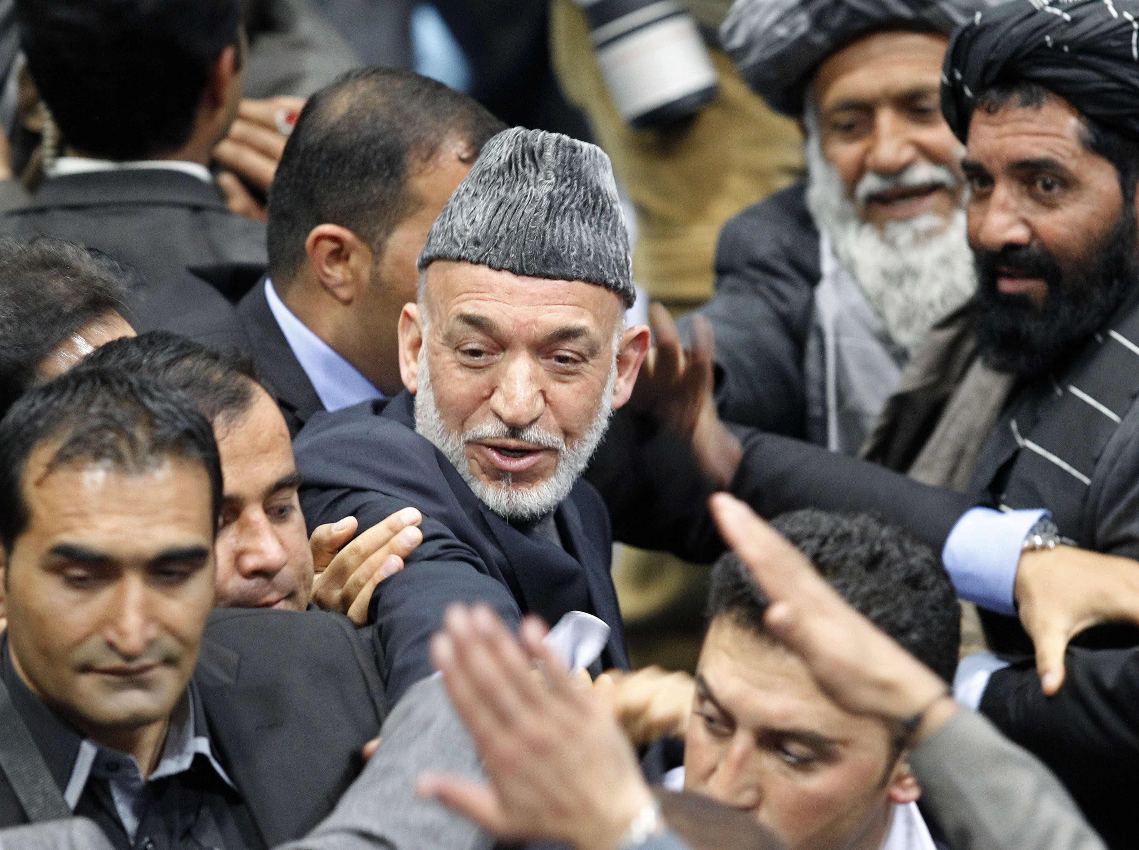 Afghan President Hamid Karzai leaves the Loya Jirga in Kabul on Sunday. Photo: 