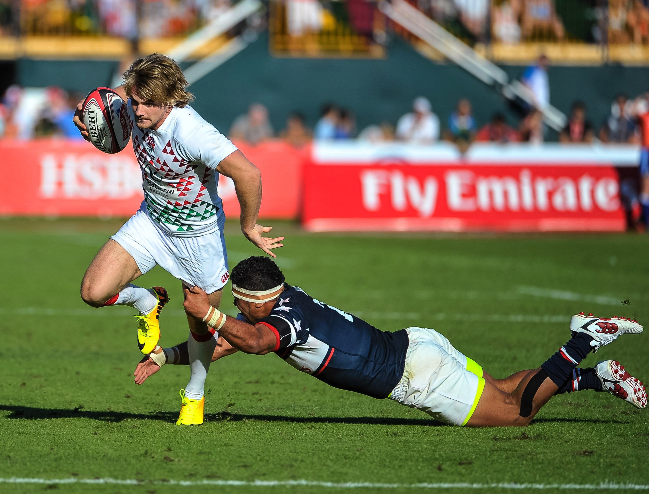 England's Sam Edgerley evades a tackle from Folau Niua of the USA during Friday's first day of action at the Dubai Sevens. Photo: AP