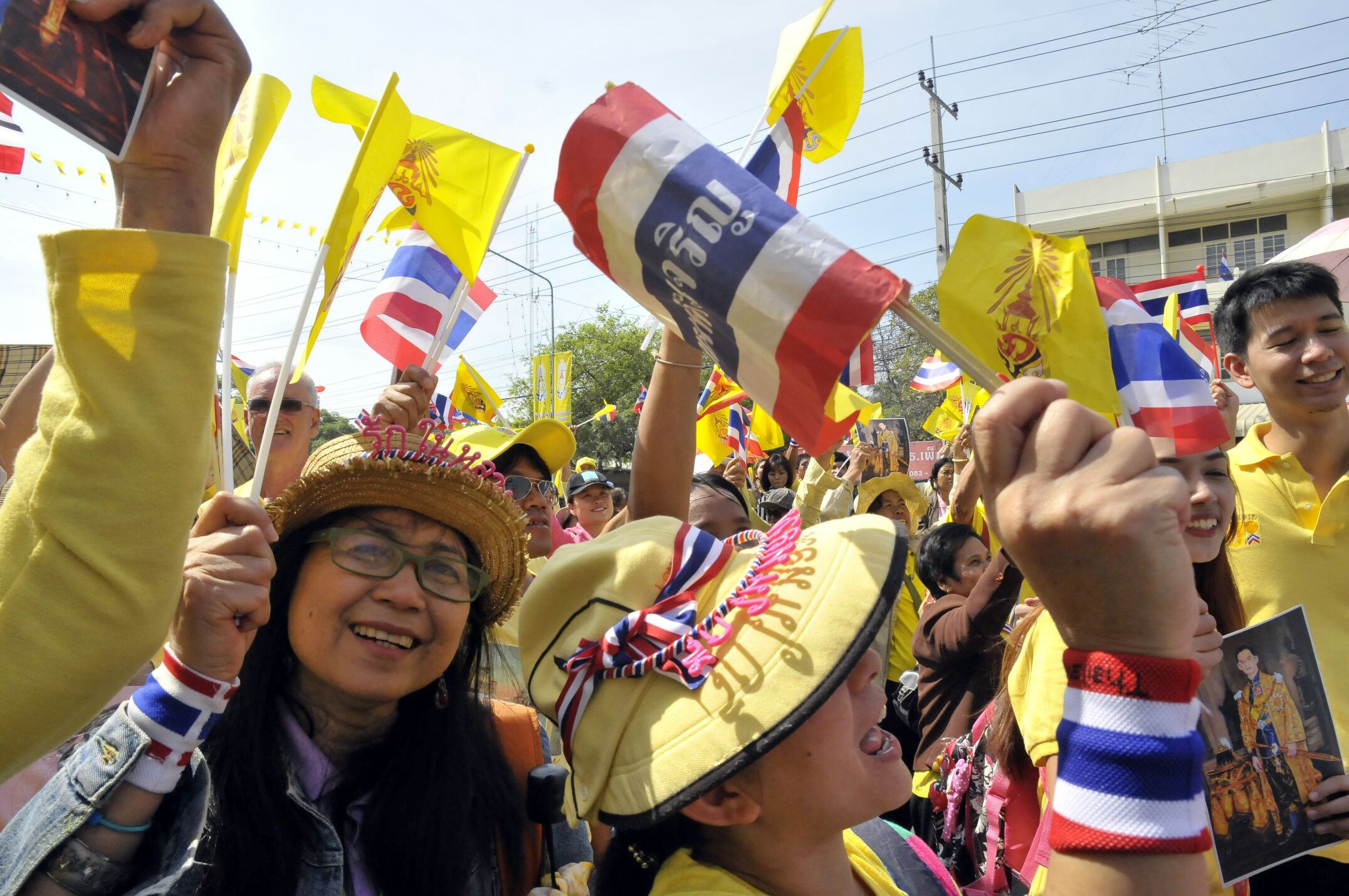 People wave flags to celebrate the Thailand's King Bhumibol Adulyadej's 86th birthday outside Klai Kangwon Palace, Khiri Khan province. Photo: Xinhua
