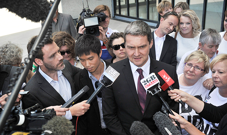 Rodney Croome (centre), director for Marriage Equality Australia talks to the media in front of the High Court of Australia in Canberra on Thursday. Photo: AFP