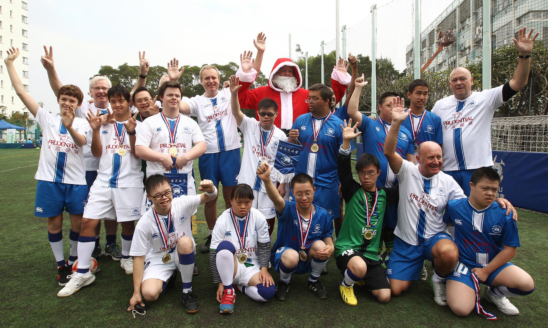 Players and coaches of the Hong Kong Football Club Crusaders at the tournament with their number one fan. Photo: Jonathan Wong