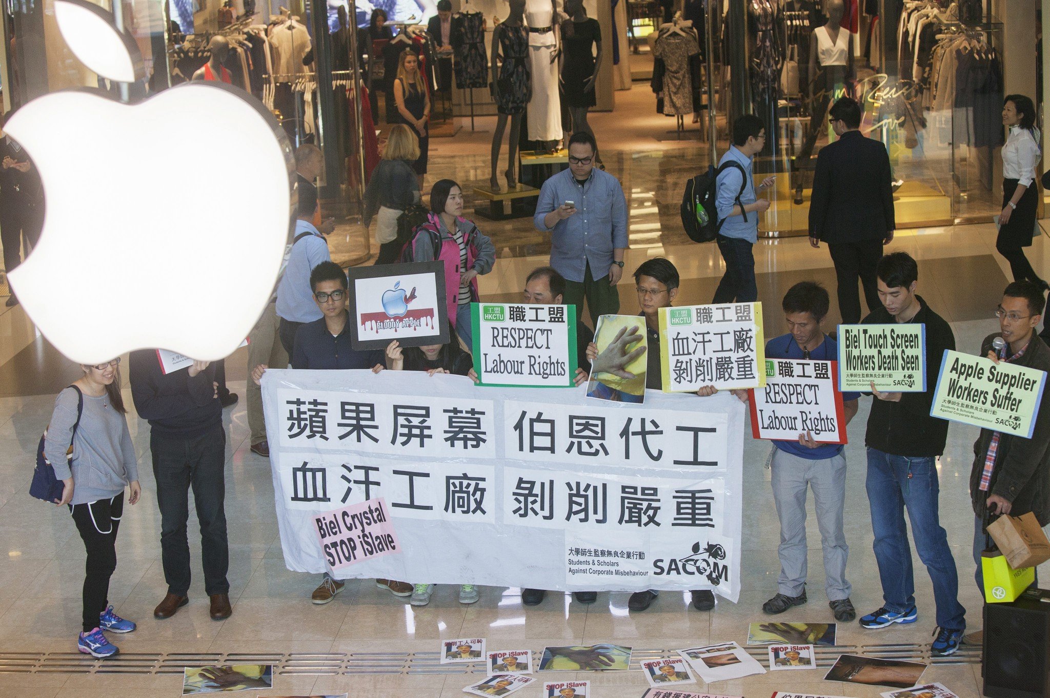  Activists from Students & Scholars Against Corporate Misbehaviour (SACOM) are seen outside Hong Kong's flagship Apple store in the International Finance Centre shopping mall in November. Photo: EPA