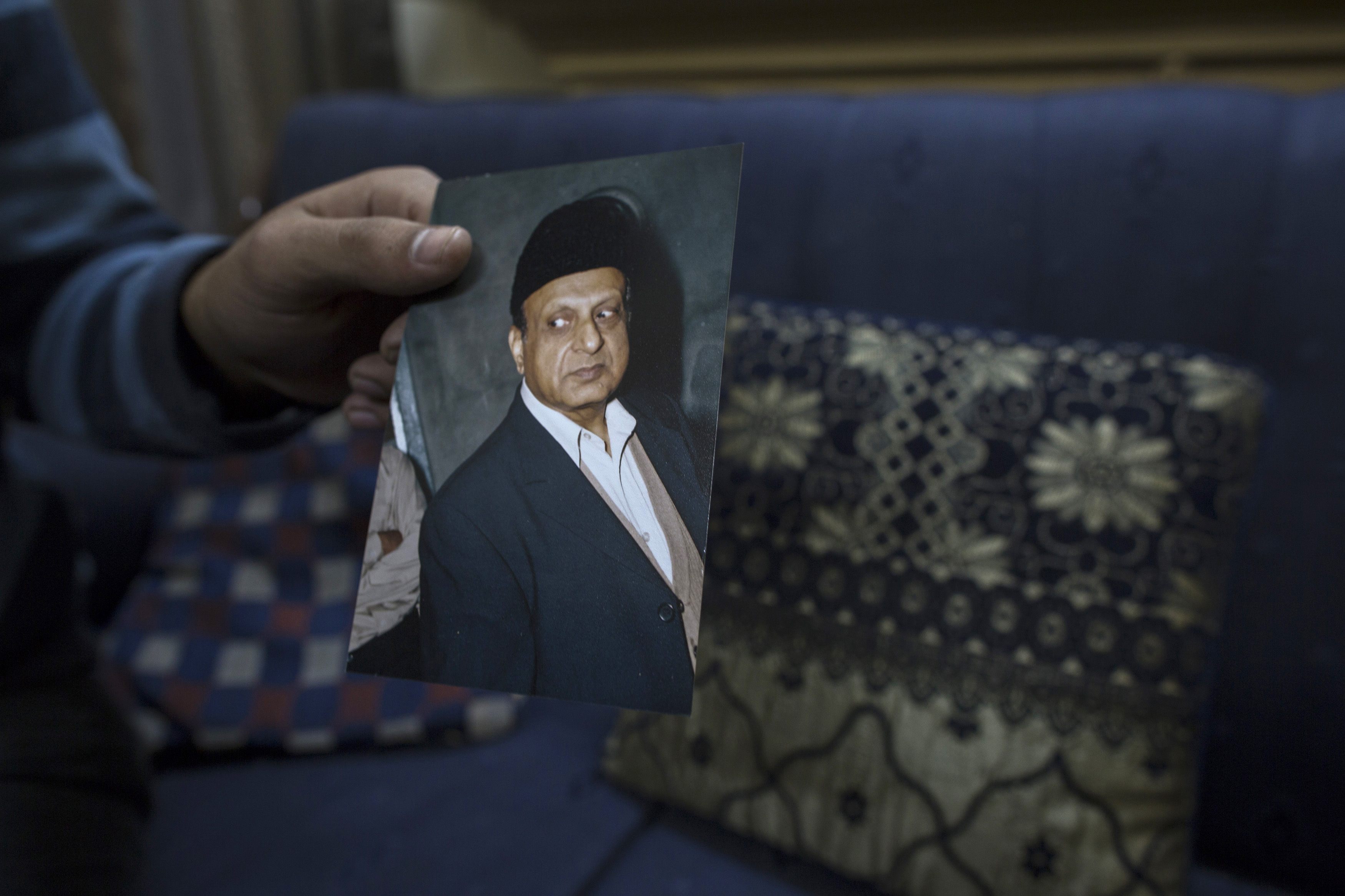A photograph of Masood Ahmad is held by his nephew at his house in Lahore. Photo: Reuters