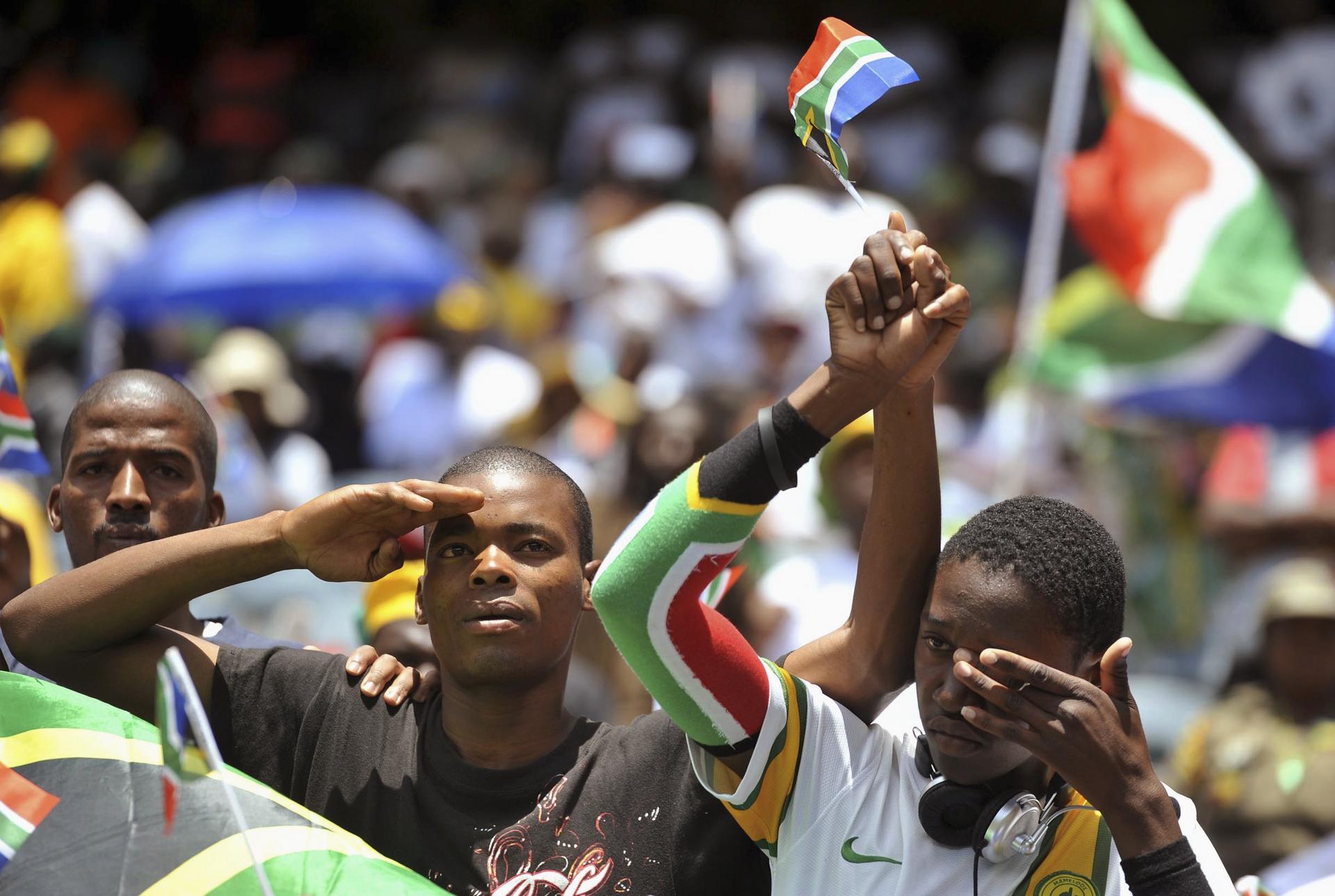 South Africans show their emotion as they watch a broadcast of Mandela's funeral at the Orlando Stadium in Johannesburg. Photo: Reuters