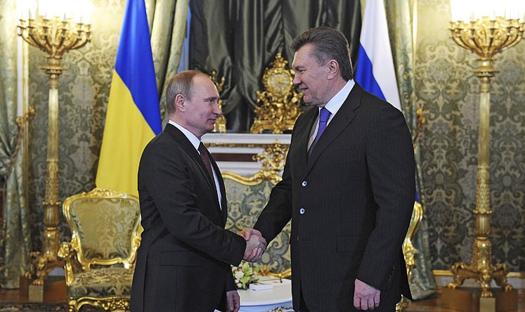 Russia's President Vladimir Putin (left) shakes hands with his Ukrainian counterpart Viktor Yanukovich during a meeting at the Kremlin in Moscow, on Tuesday. Photo: Reuters