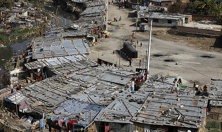 Shabby tin-roofed huts house more than 10,000 people along the banks of the Bagmati river in Kathmandu. Photo: AFP
