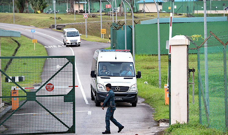 An Immigration and Customs Authority van, transporting arrested foreign workers, leaves Admiralty West Prison in Singapore. Photo: AFP