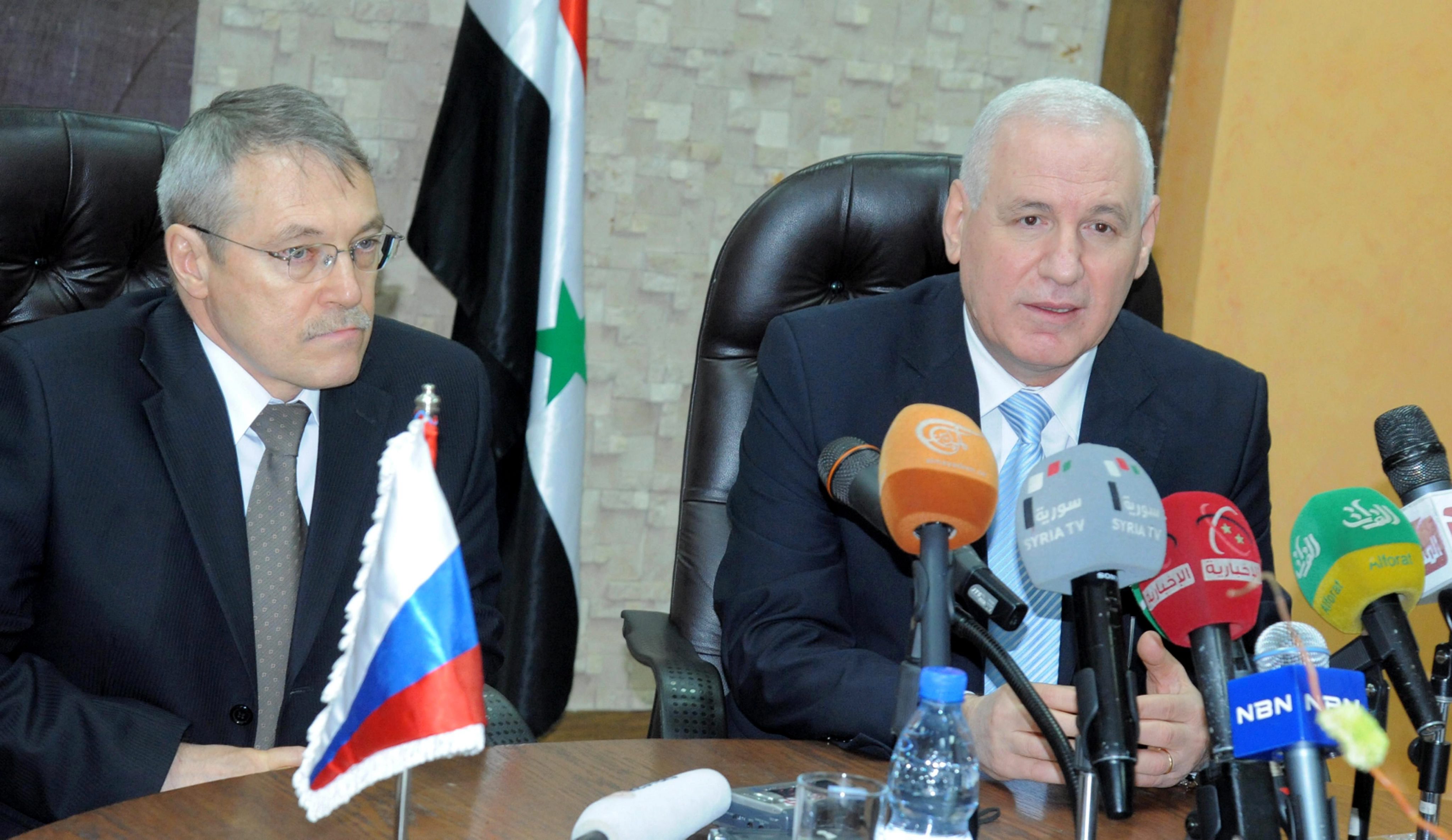 Syria's Oil Minister Suleiman Abbas (right) and Russia's Ambassador in Damascus Azmatullah Kulmohammadov sign an oil agreement in Damascus on Wednesday. Photo: EPA