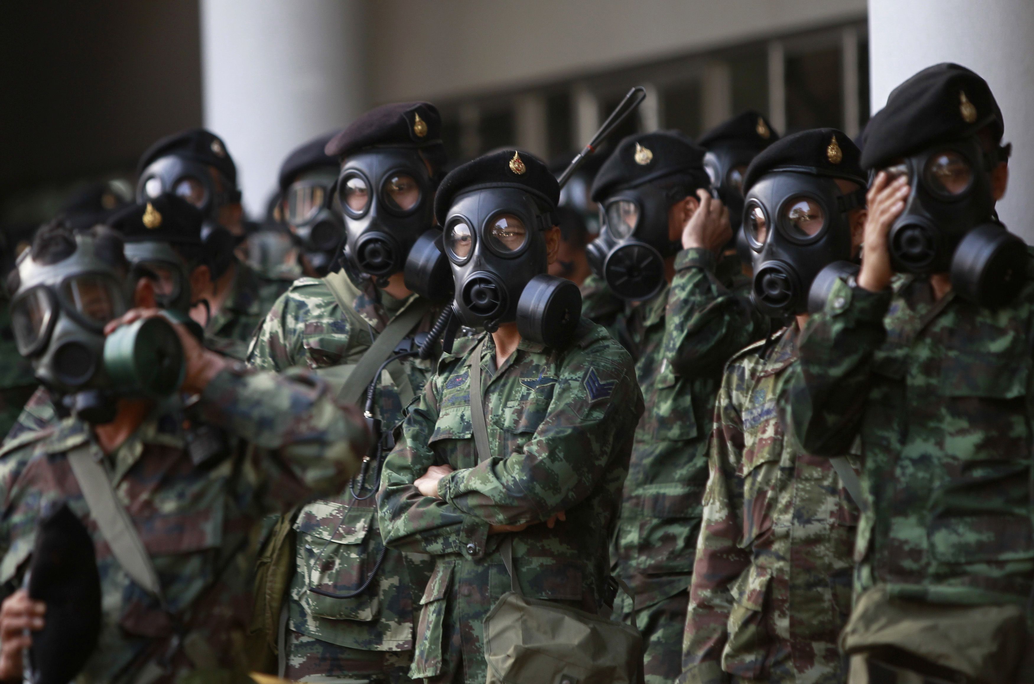 Thai soldiers wear gas masks as they stand guard at the Thai-Japan youth stadium in central Bangkok. Photo: Reuters