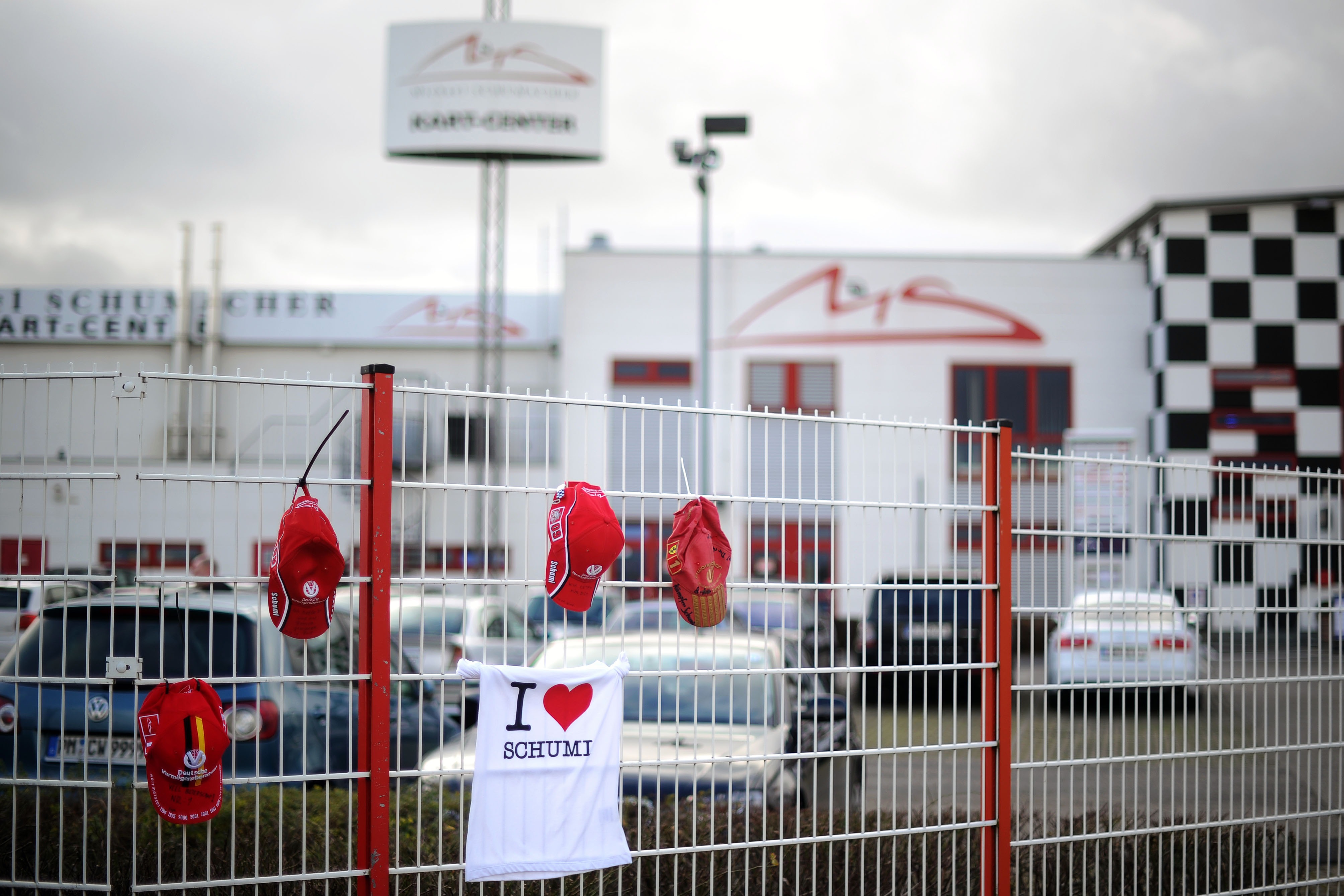 Michael Schumacher fan caps and a fan T-shirt are attached on the fence at the Michael Schumacher Cart Centre in his home town Kerpen, Germany. Photo: AP
