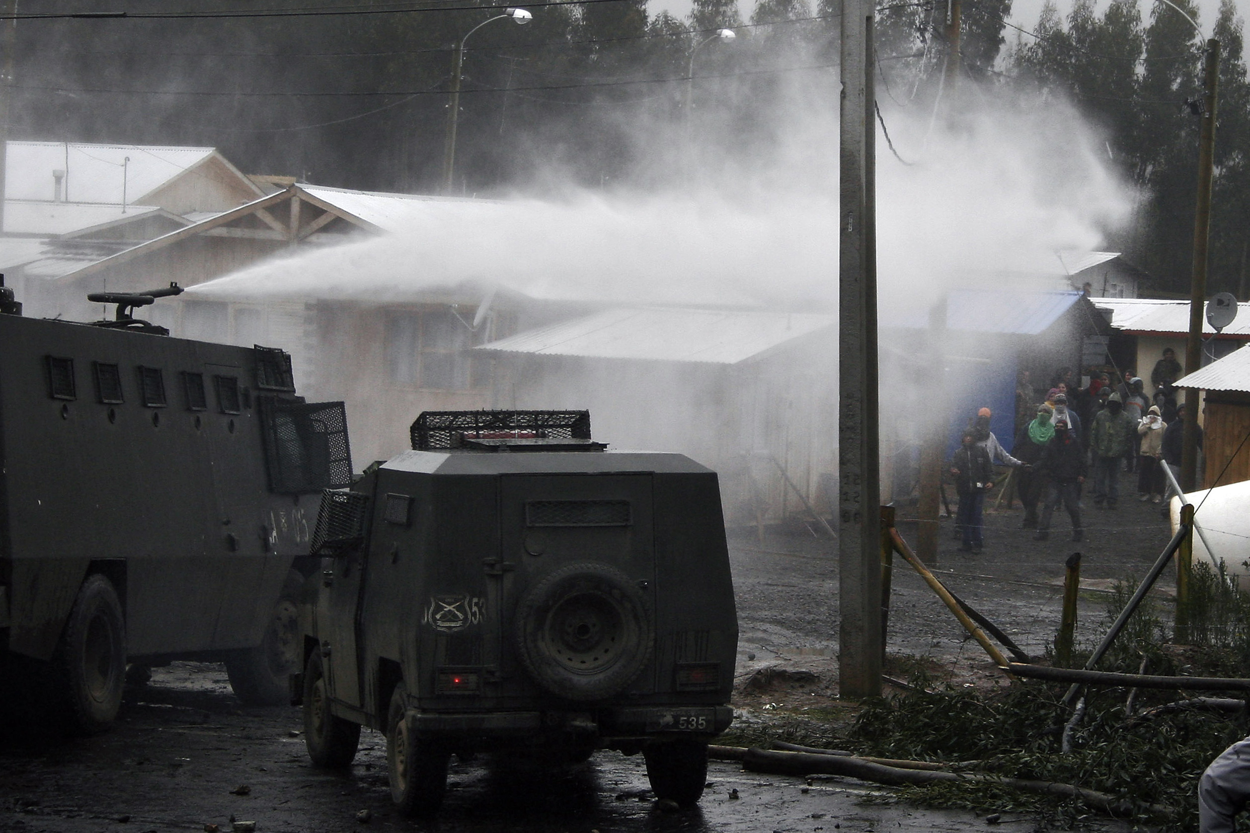Residents are dispersed as the Police uses a water cannon during a protest in Dichato, a coastal town about 500 kms south of Santiago, Chile, Thursday, July 21, 2011. Photo: AP