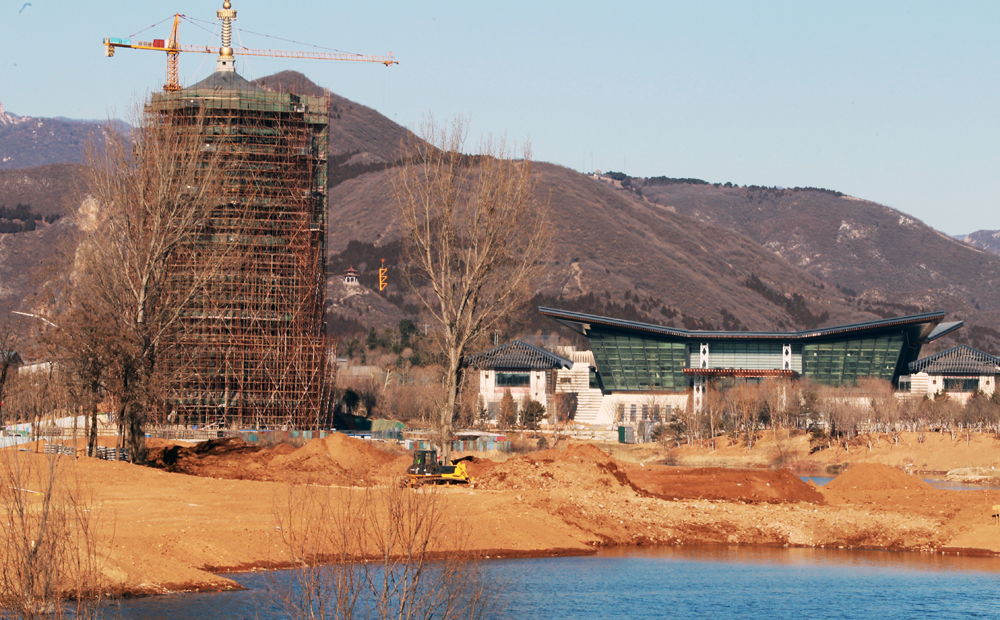 The main conference hall (right) and the observation tower of the Yanqihu (Yanqi Lake) Conference Resort, are under construction. The conference resort will hold the APEC meeting in 2014. Photo: Simon Song