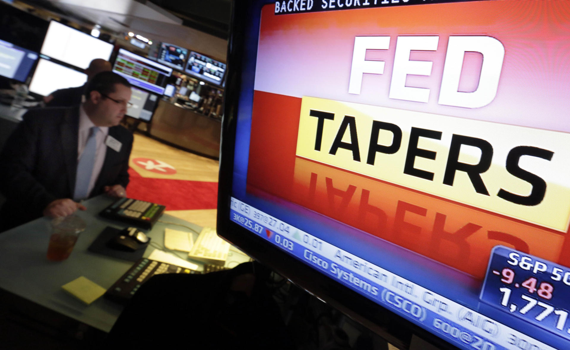 A television screen shows the Federal Reserve's decision on bond purchases after its policy meeting last month. Photo: AP