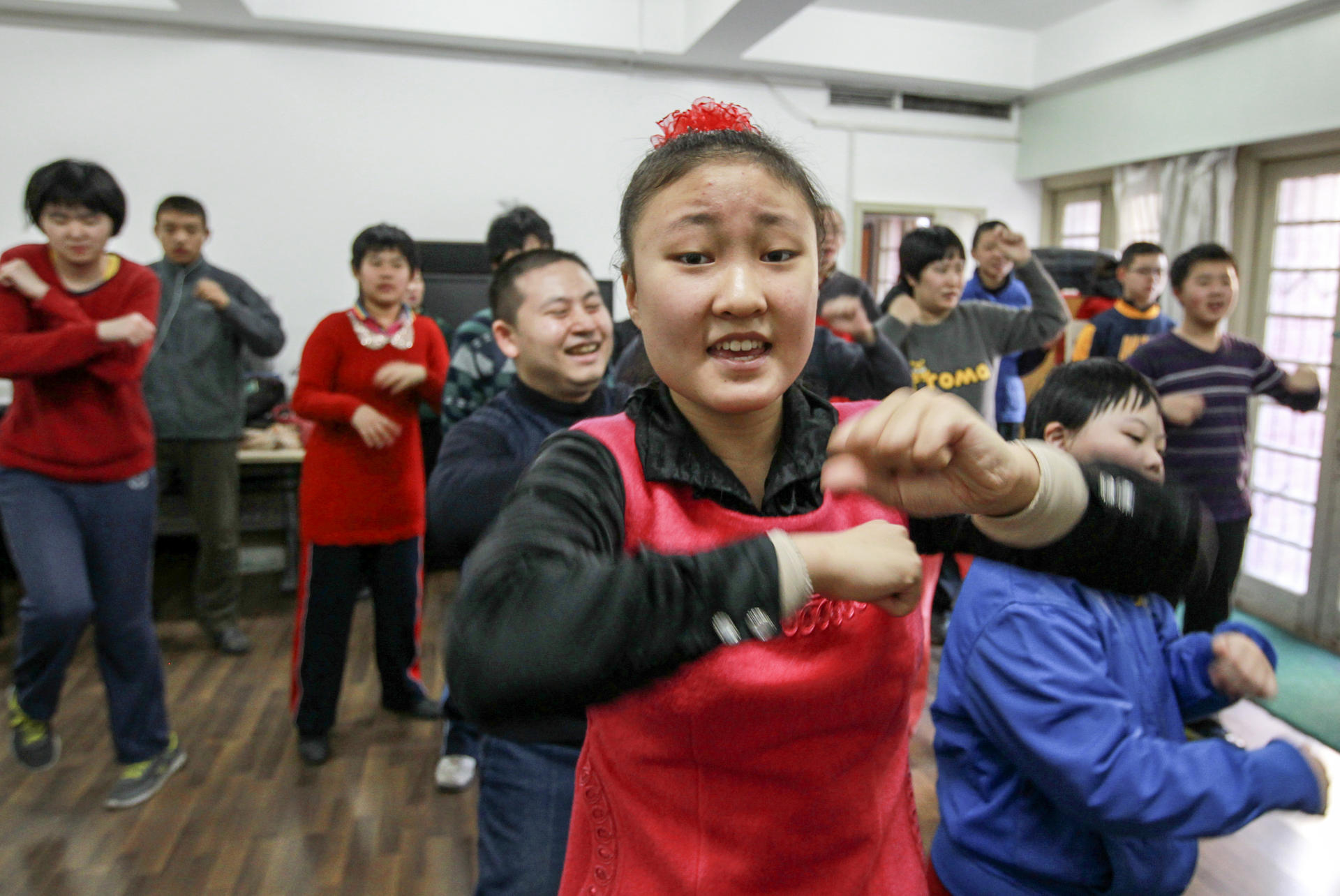 Children with developmental problems enjoy a dance routine at Yu Huigeng's music therapy session in Beijing. Photos: Simon Song