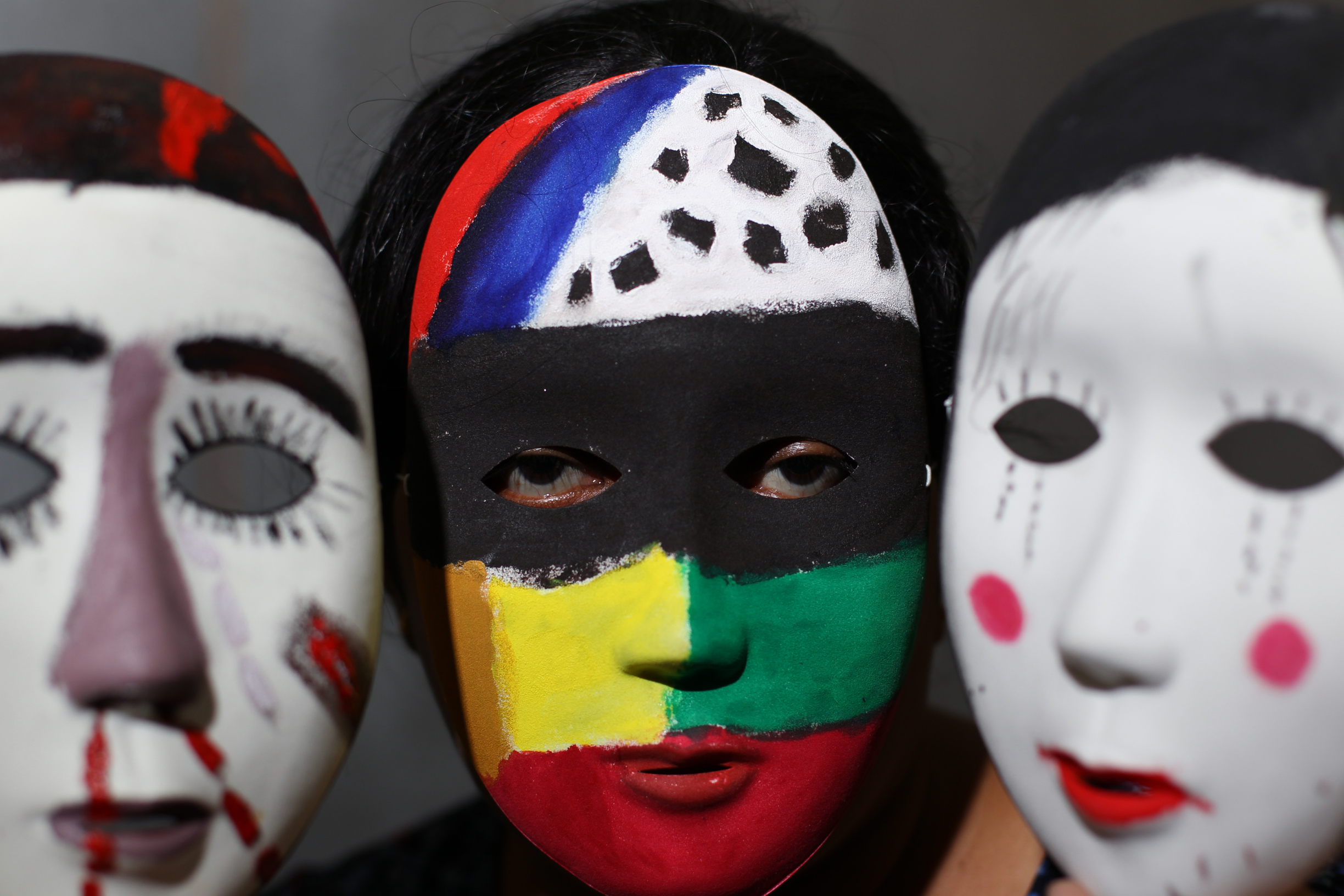 Asylum seeker Shirley (centre, full name withheld) from Sri Lanka poses with masks at an art exhibition on asylum seekers in Hong Kong. Photo: Nora Tam