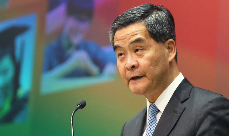 Chief executive Leung Chun-ying poses for the photographers with hard copies of Policy Address 2014 in a press conference. Photo: K. Y. Cheng